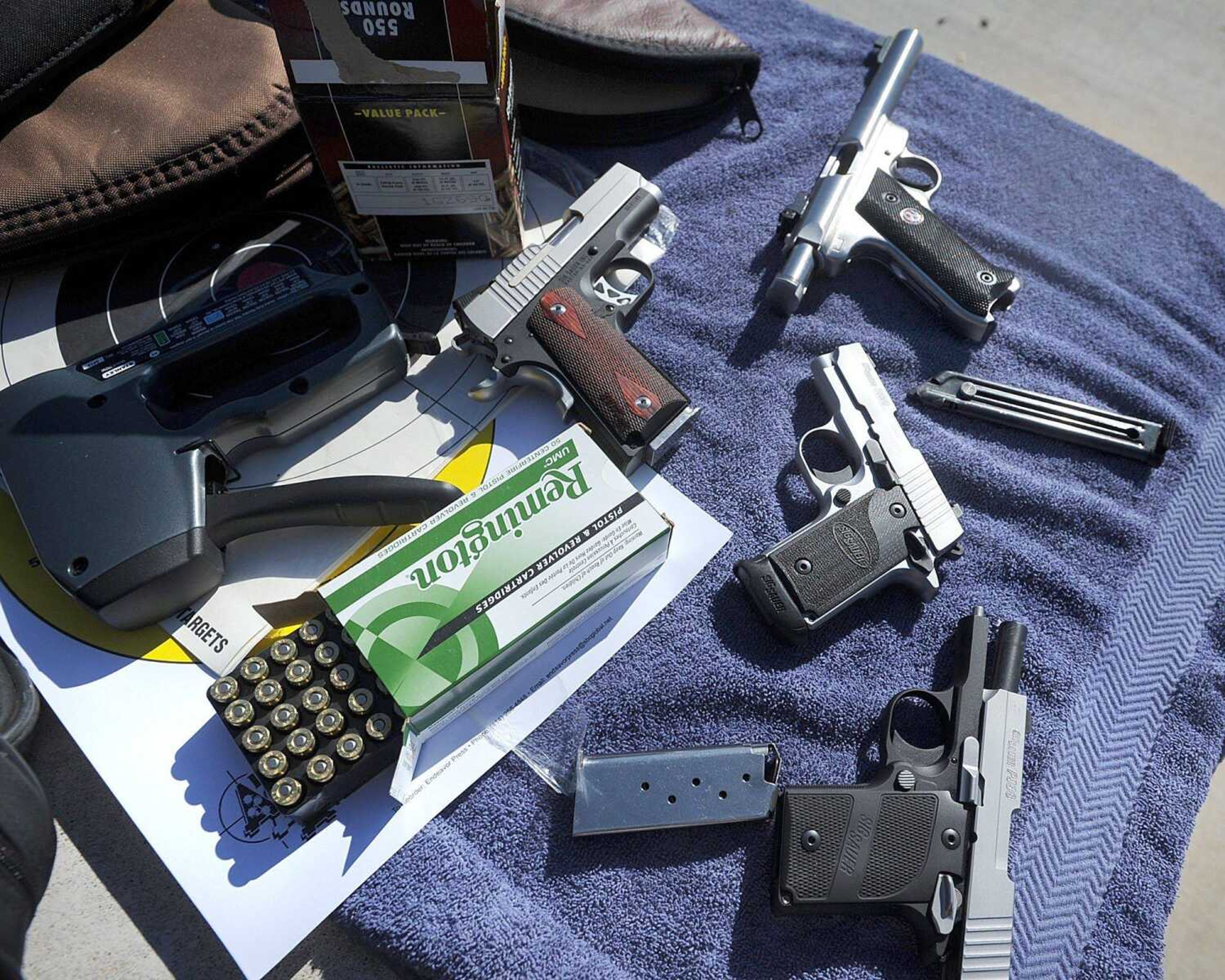 An array of handguns including a 9-mm, .22, .45 and .380 wait for their turn during target practice Wednesday at the Missouri Department of Conservation's Apple Creek shooting range. (Laura Simon)