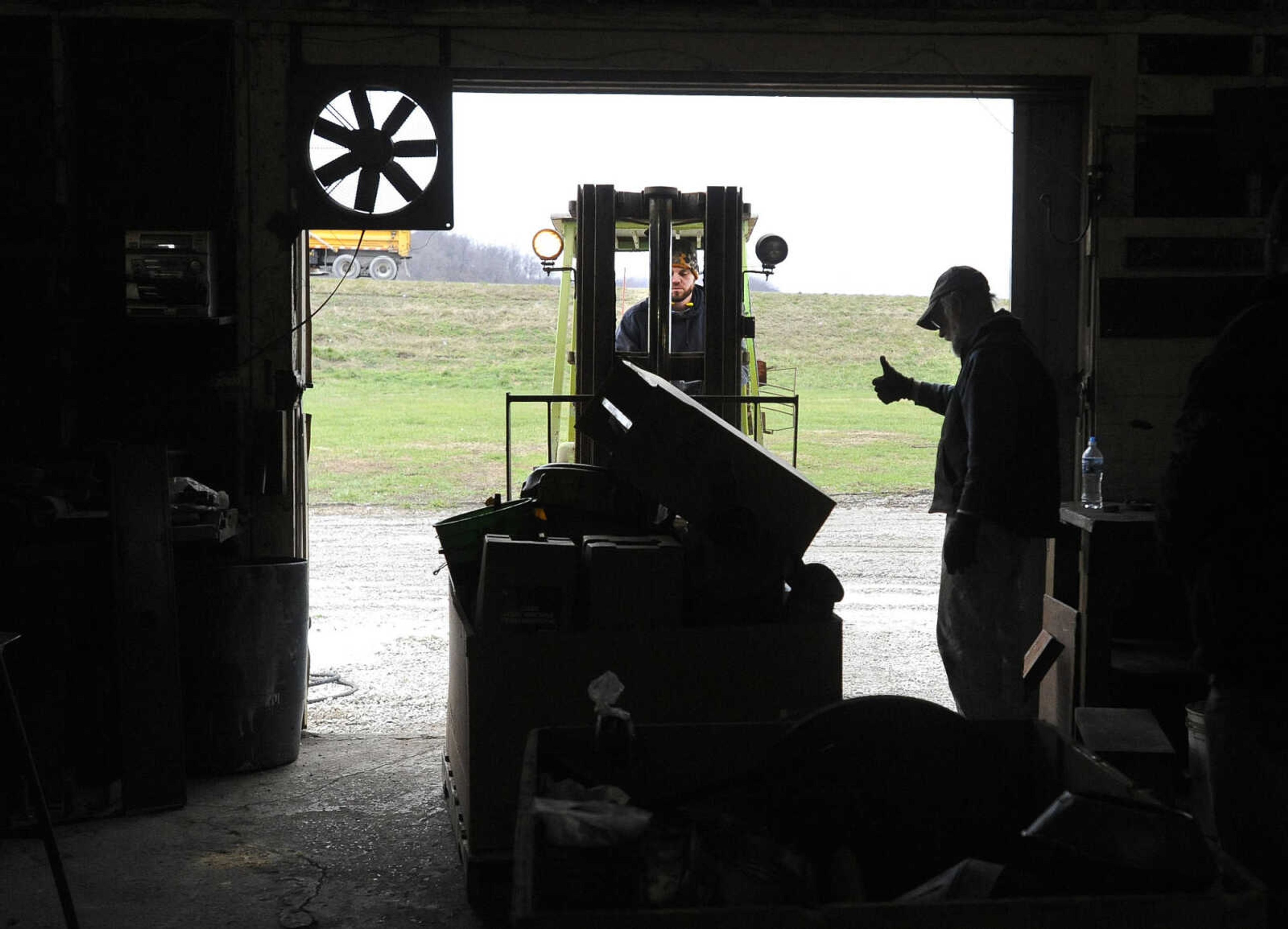 LAURA SIMON ~ lsimon@semissourian.com

Mike Ernst, right, gives a thumbs-up to Brian Birchler as Birchler removes a load of equipment from Ernst Service Station & Machine Shop to take to a higher location, Tuesday, Dec. 29, 2015, in McBride, Missouri.