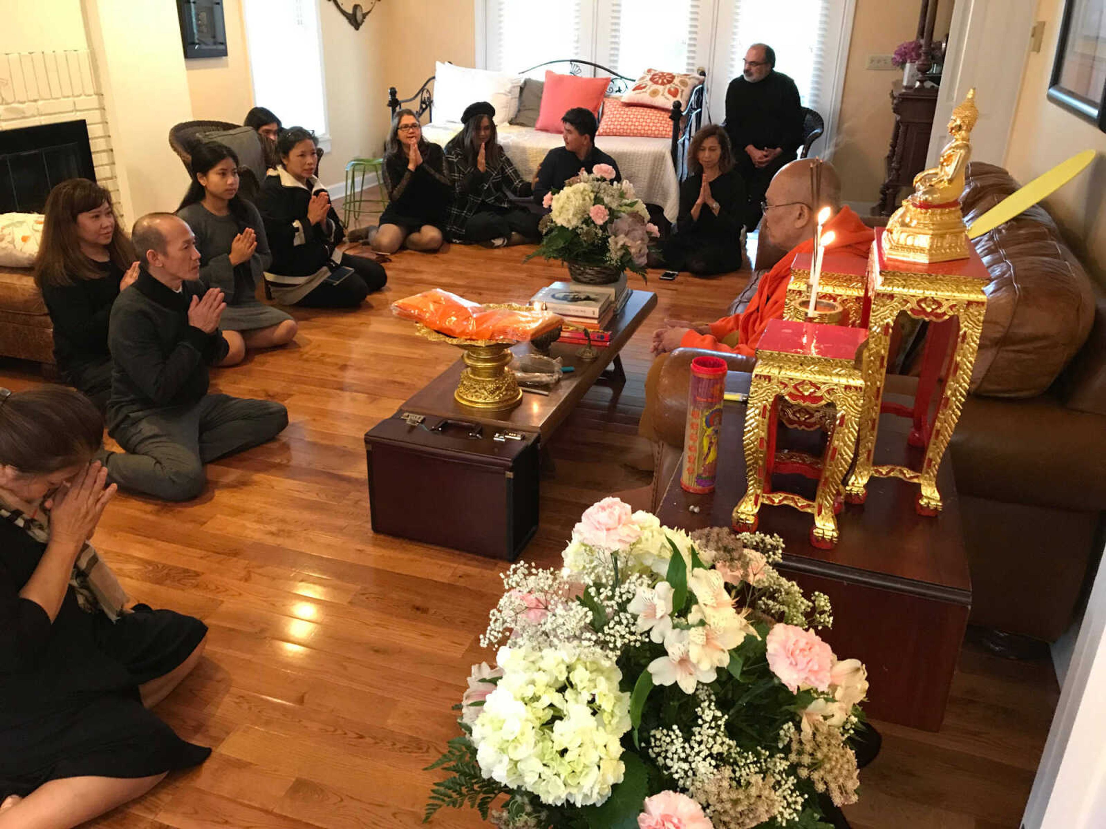 The children and family gather at Su’s home in Cape Girardeau in November 2018 to show respect for their mother, Pratinrat Saysanan, who died Oct. 31, 2018. Services were led by a Buddhist monk from the Wat Phrasriratanaram Temple located in St. Louis.