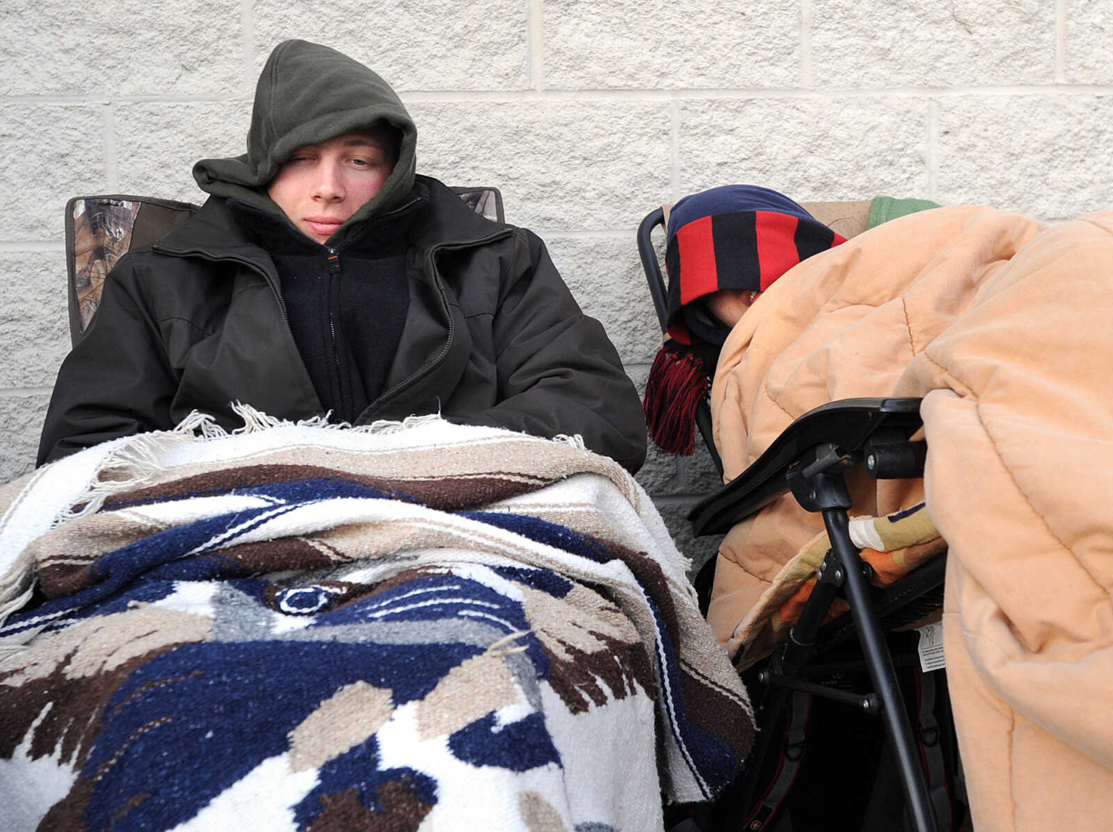 LAURA SIMON ~ lsimon@semissourian.com
Reece Thompson, left, and Serena Poppen kick back under layers of blankets and coats as they wait in line outside Best Buy Thursday, Nov. 22, 2012 in Cape Girardeau. The duo set up camp outside the retailer around 7:30 p.m. Wednesday. On their list were tablets, PS3's, laptops and televisions.