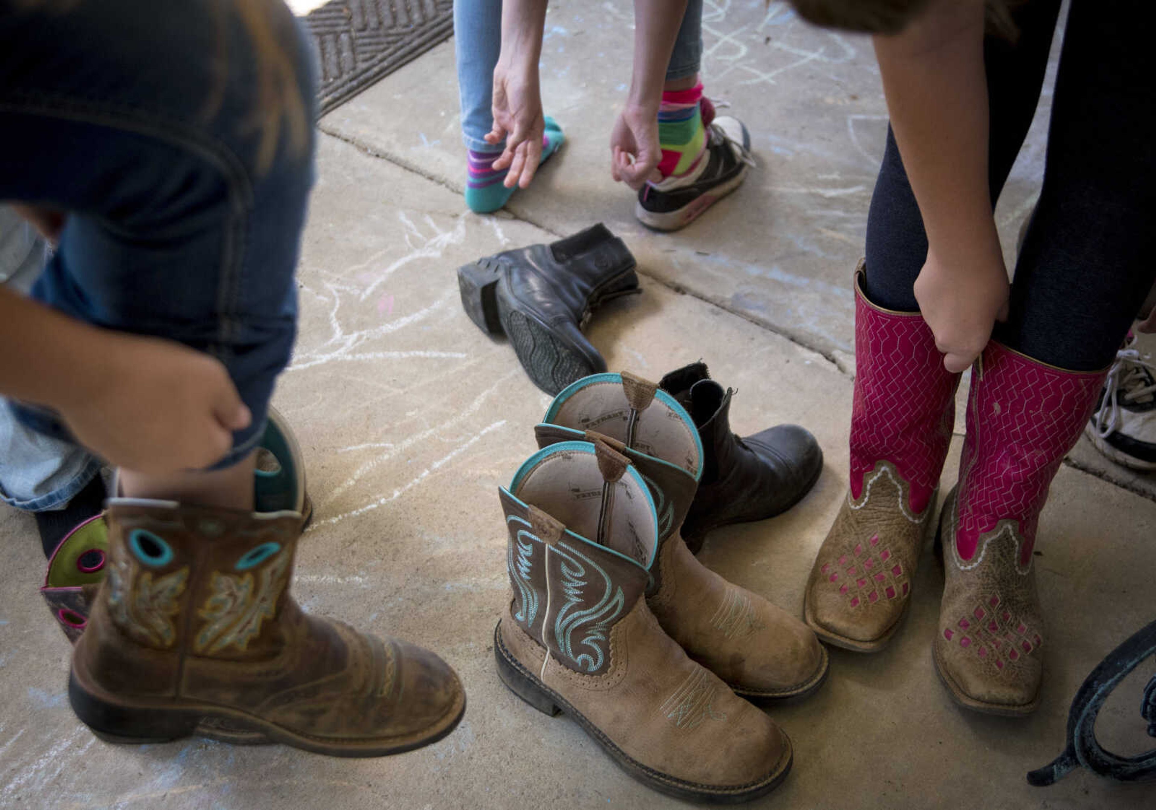 Campers put on their boots during the Rolling Hills Youth Day Camp Wednesday, June 7, 2017 in Cape Girardeau.