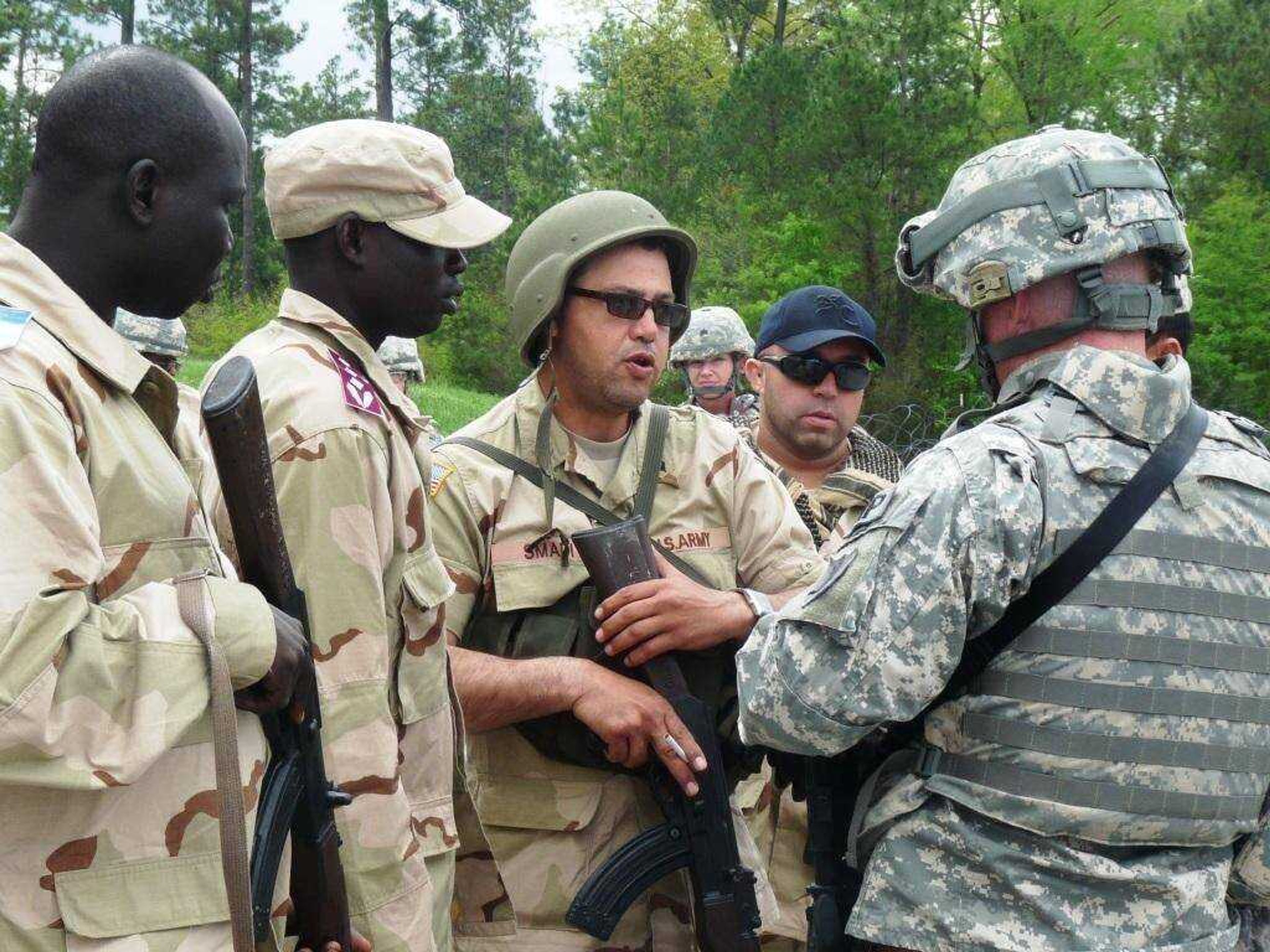 Maj. Adam Reichart (r) speaks with role-players during a training exercise at Camp Shelby, Miss. The exercise was designed to help familiarize Soldiers with the various ways they’ll work and interact with the Afghan Border Police. (Photo by Ashley Ward)