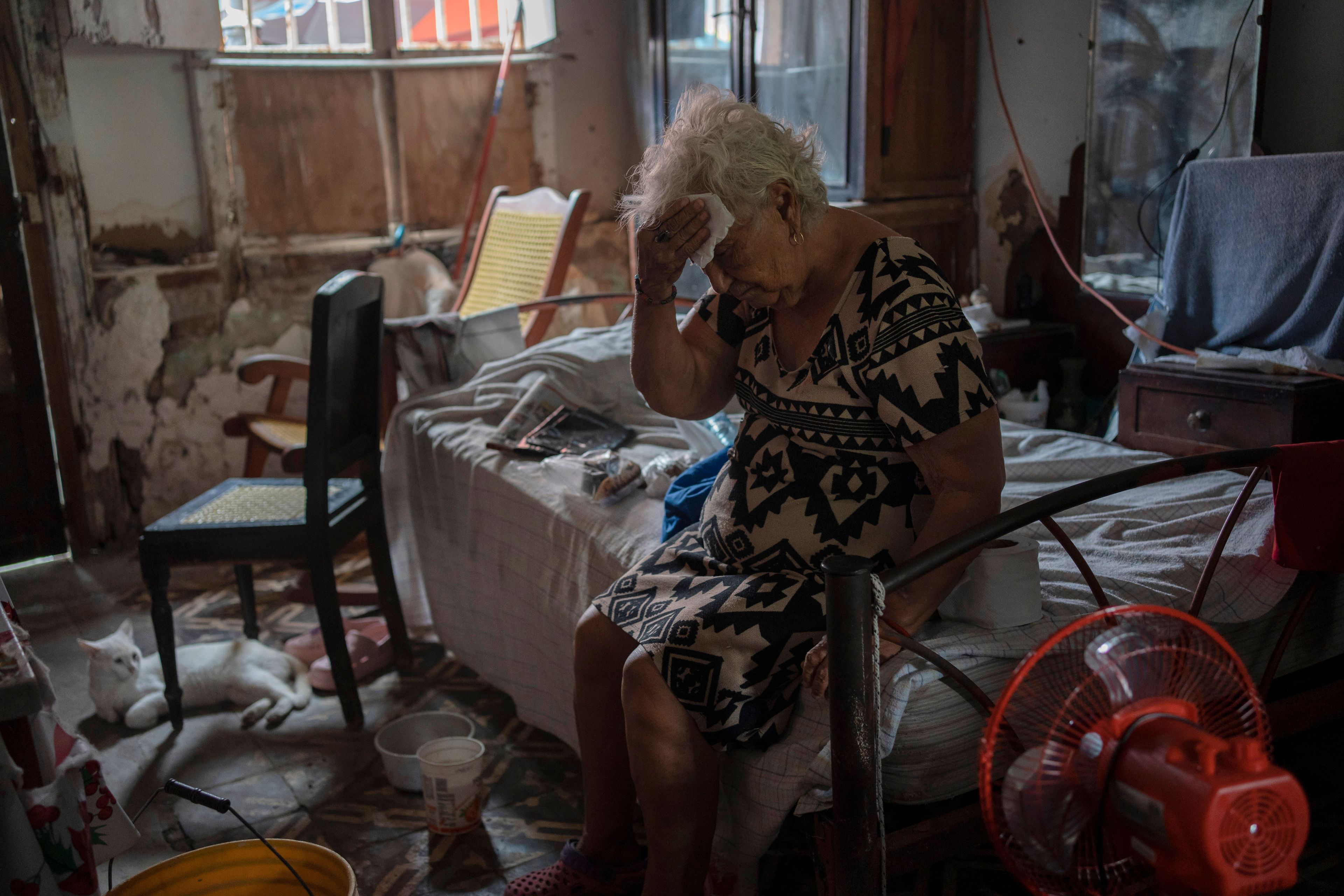 FILE - Margarita Salazar wipes sweat off her brow inside her home amid high heat in Veracruz, Mexico, June 16, 2024. (AP Photo/Felix Marquez, File)