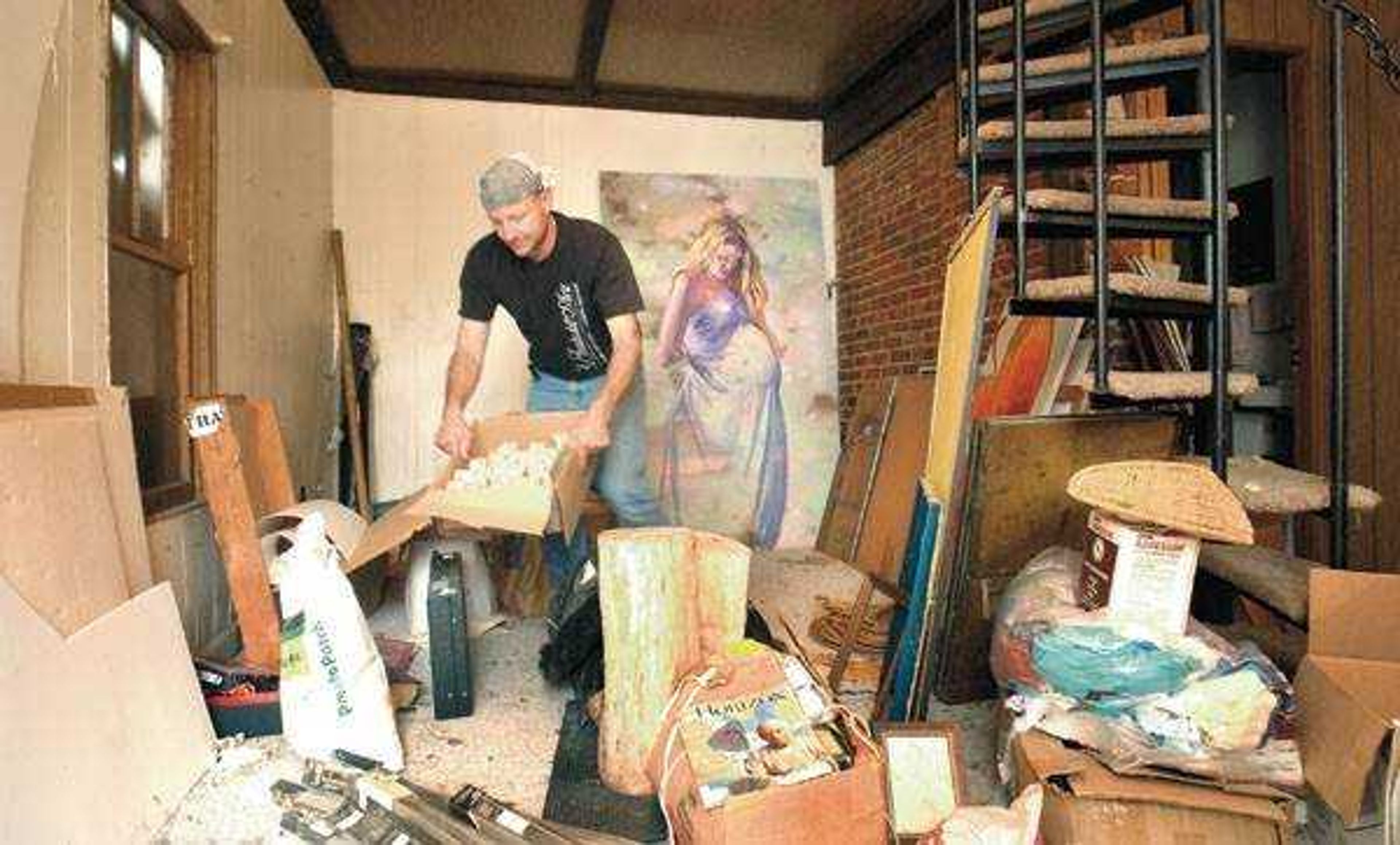 Cape Girardeau artist Craig Thomas on Wednesday cleaned out a small building on his property to be used as an art studio. (Don Frazier)