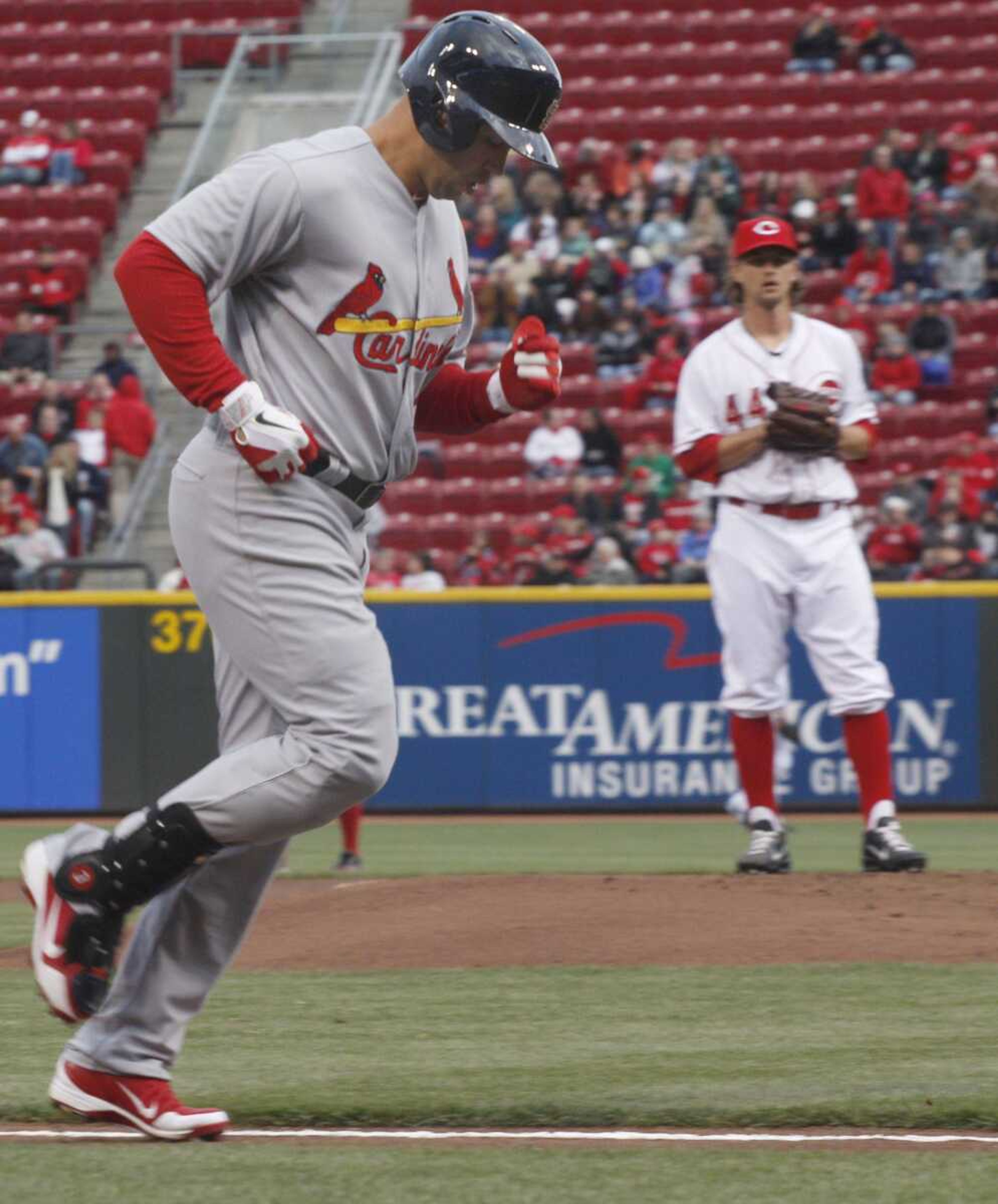 Cardinals outfielder Carlos Beltran circles the bases after hitting a home run during the first inning Tuesday in Cincinnati. Reds pitcher Mike Leake looks on. (Tom Uhlman ~ Associated Press)