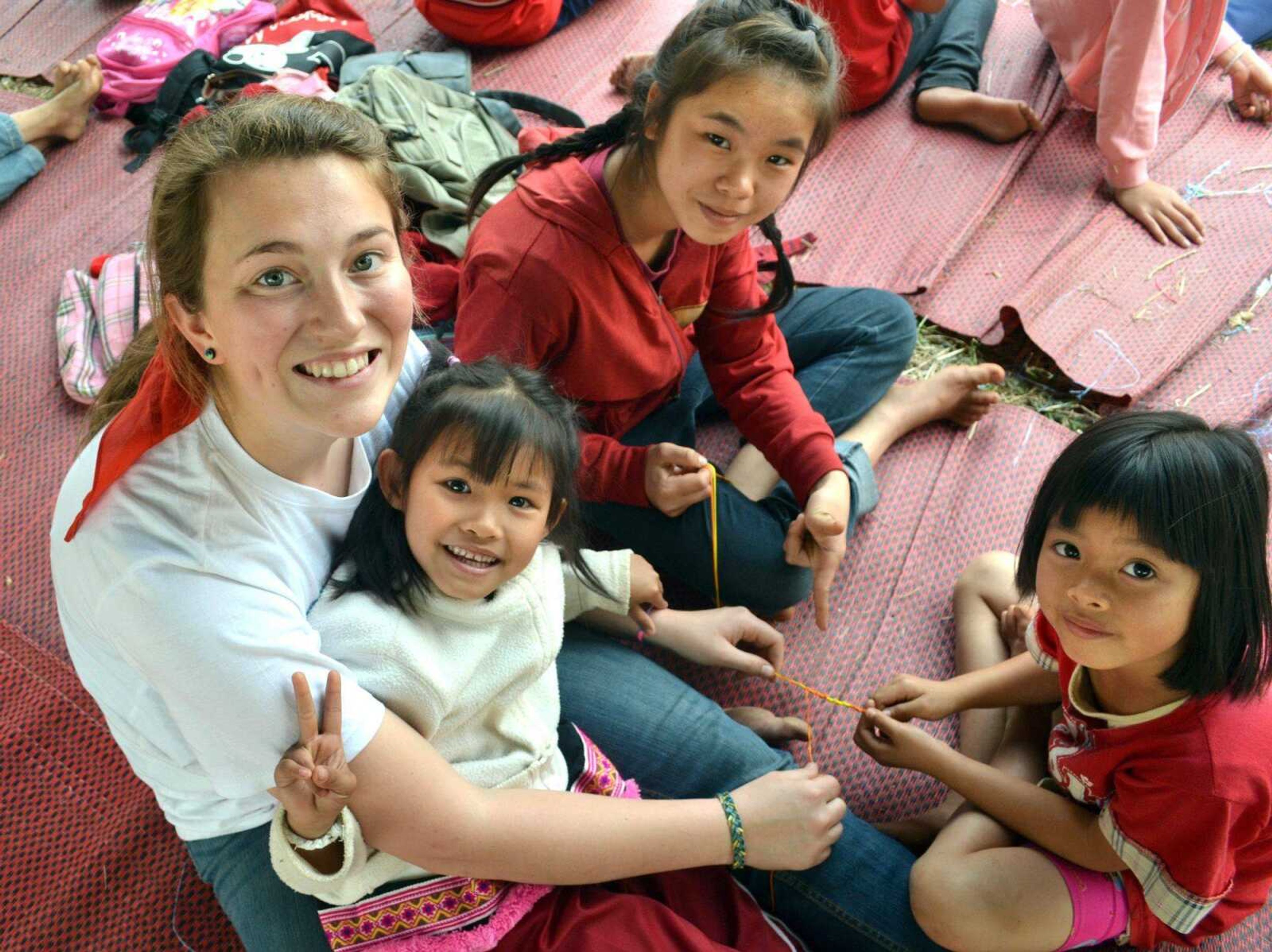 Felicia Bratti of Glenallen, Mo., is shown making bracelets with children in Thailand. (Submitted photo)