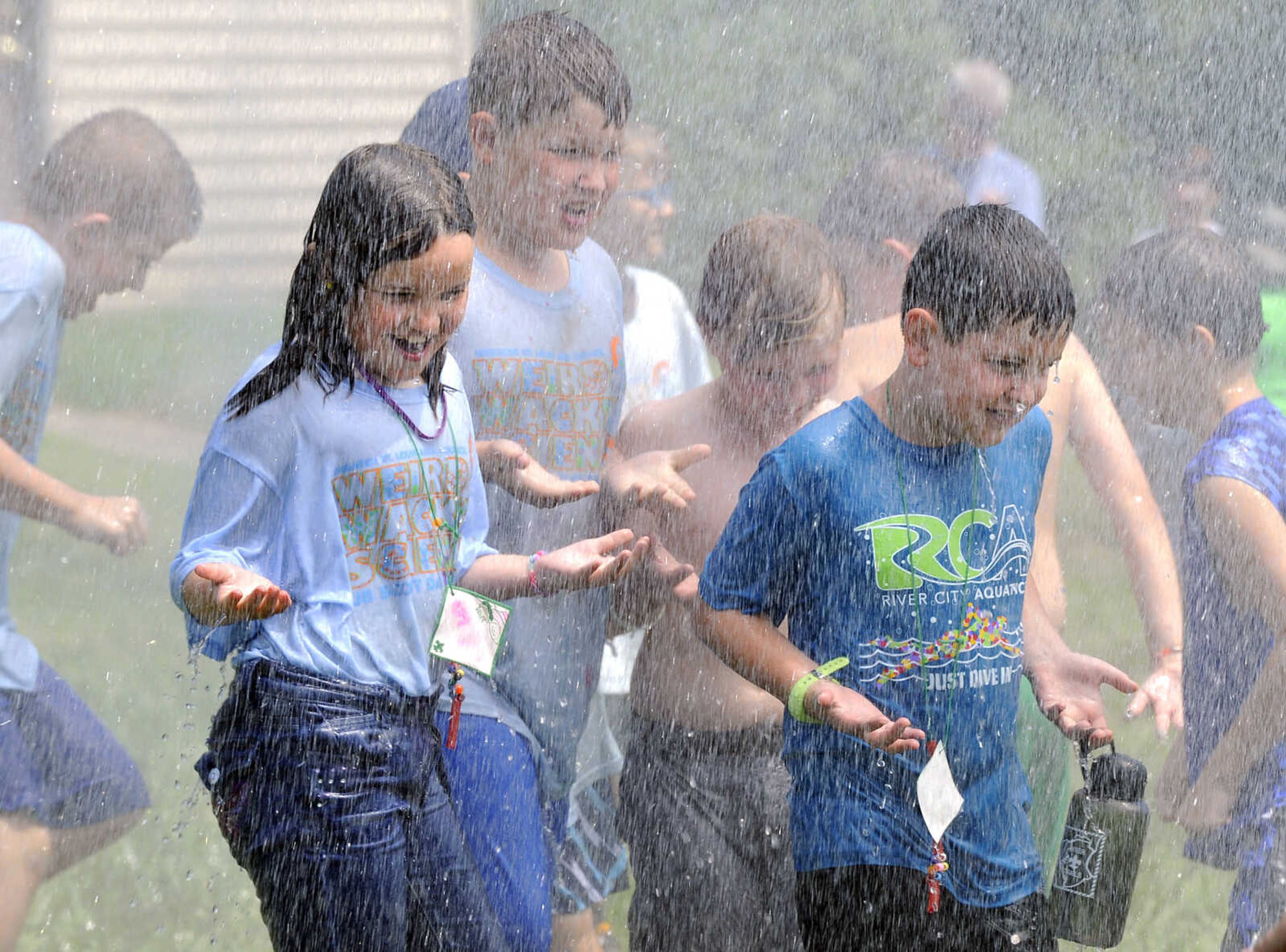 FRED LYNCH ~ flynch@semissourian.com
Youngsters at Scout camp cool off with a late-morning shower Thursday, July 12, 2018 provided by a pumper from the Cape Girardeau Fire Department at Cape County Park North.