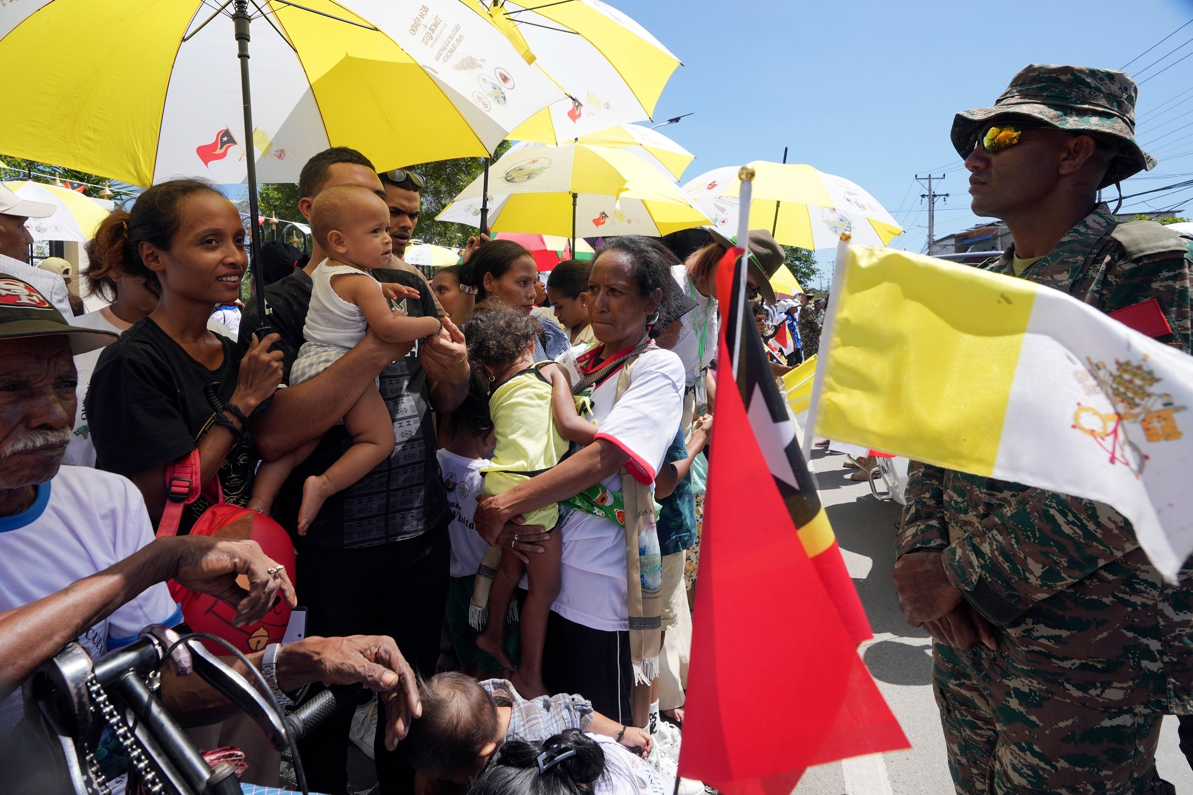 People wait for Pope Francis near the Cathedral of the Immaculate Conception in Dili, East Timor, Tuesday, Sept. 10, 2024. (AP Photo/Firdia Lisnawati)