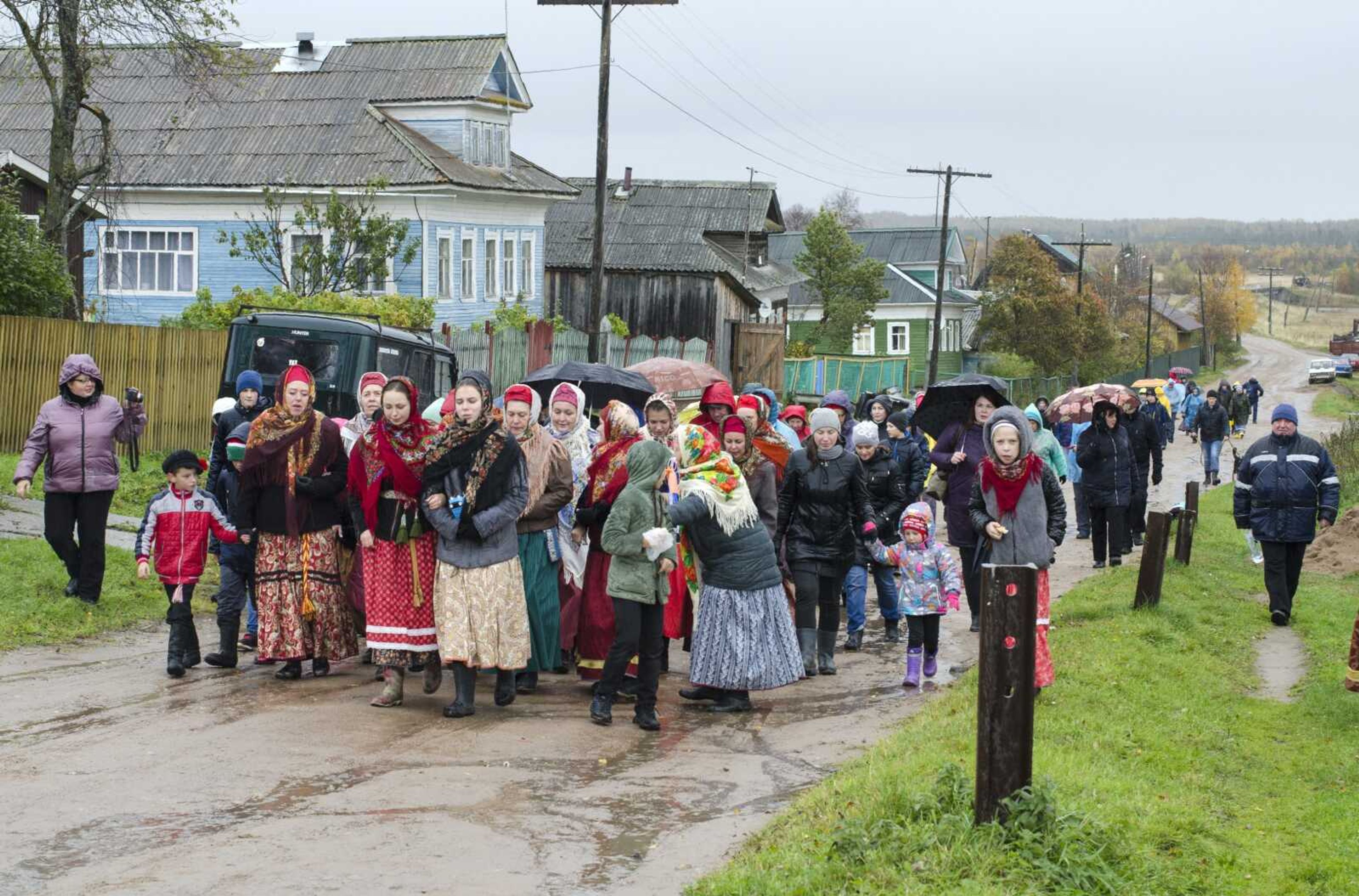 Residents dressed in folk costumes walk through a street during an October folk festival in the village of Nyonoksa, northwestern Russia. The Aug. 8, explosion of a rocket engine at the Russian navy's testing range just outside Nyonoksa led to a brief spike in radiation levels and raised new questions about prospective Russian weapons.