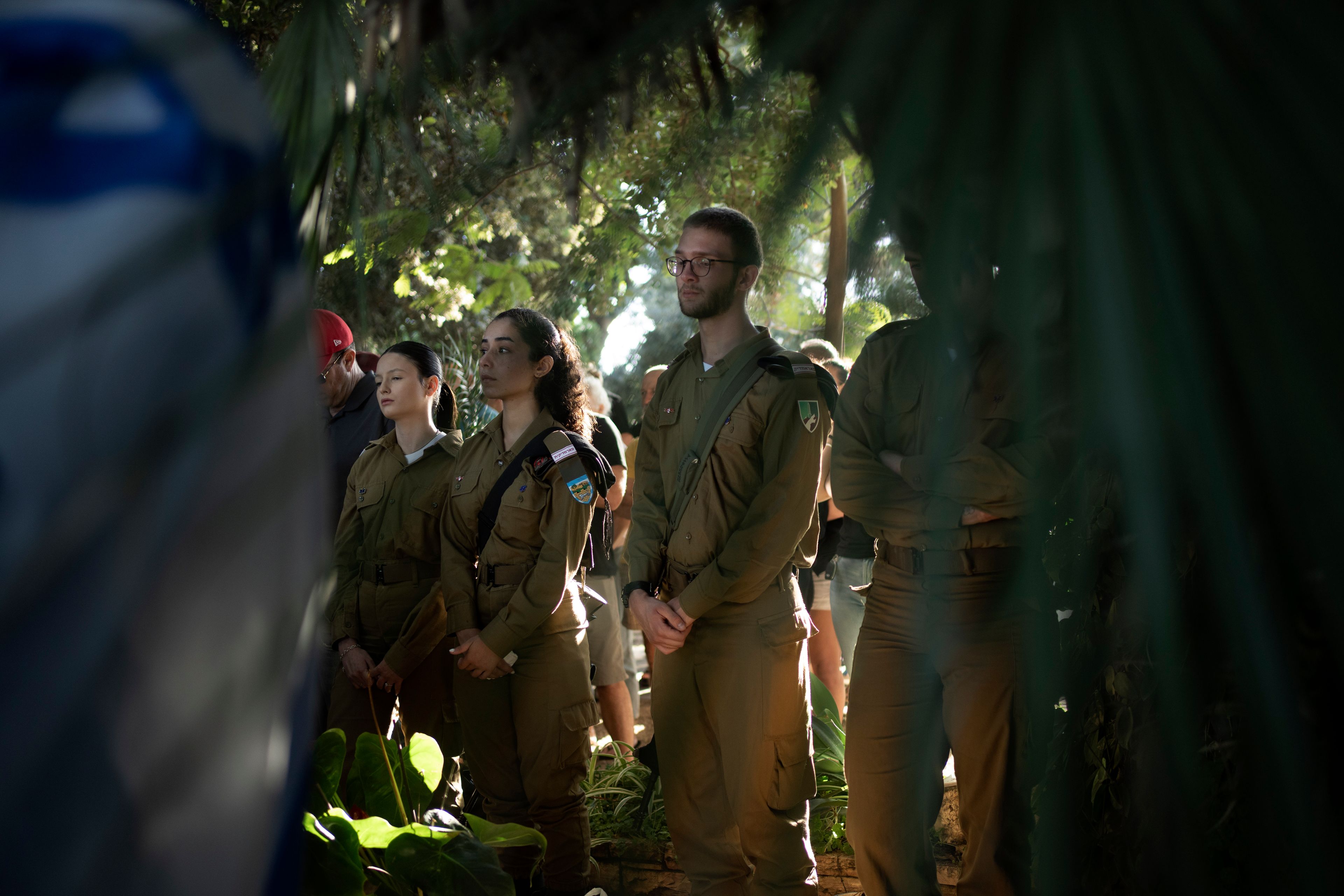 Israeli soldiers attend the funeral for Israeli Defense Forces paramedic Sgt. Agam Naim, the first woman Israeli Defense Forces soldier killed in combat in the Gaza Strip, in Kibbutz Mishmarot, Israel, Wednesday, Israel, Sept. 18, 2024. (AP Photo/Maya Alleruzzo)