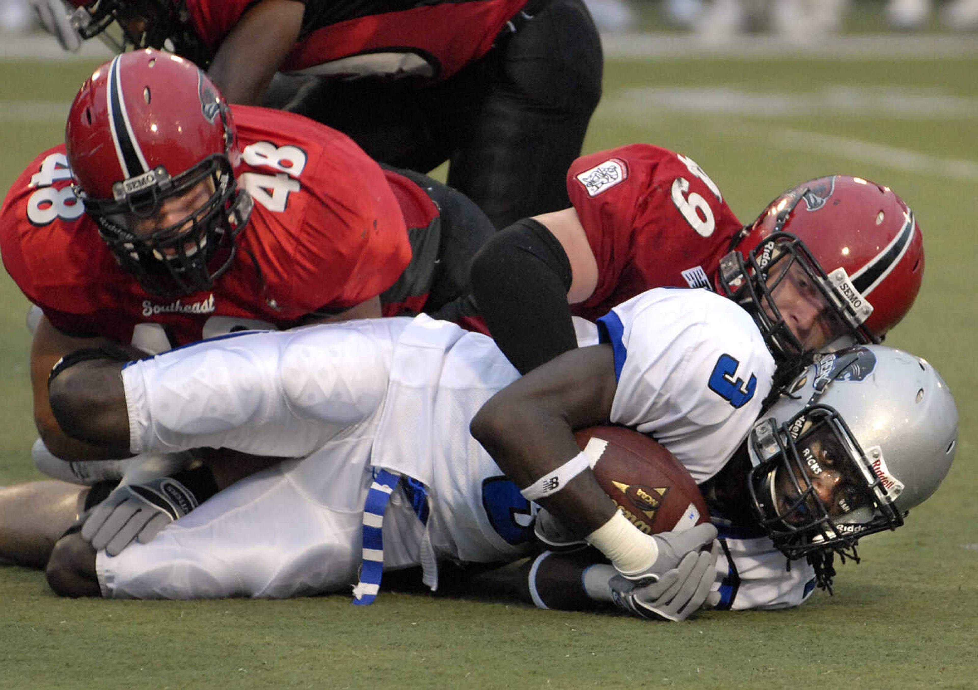 FRED LYNCH ~ flynch@semissourian.com
Southeast Missouri State defenders Philip Klaproth, left, and Justin Woodlief bring down Eastern Illinois wide receiver Lorence Ricks during the first quarter Saturday at Houck Stadium.