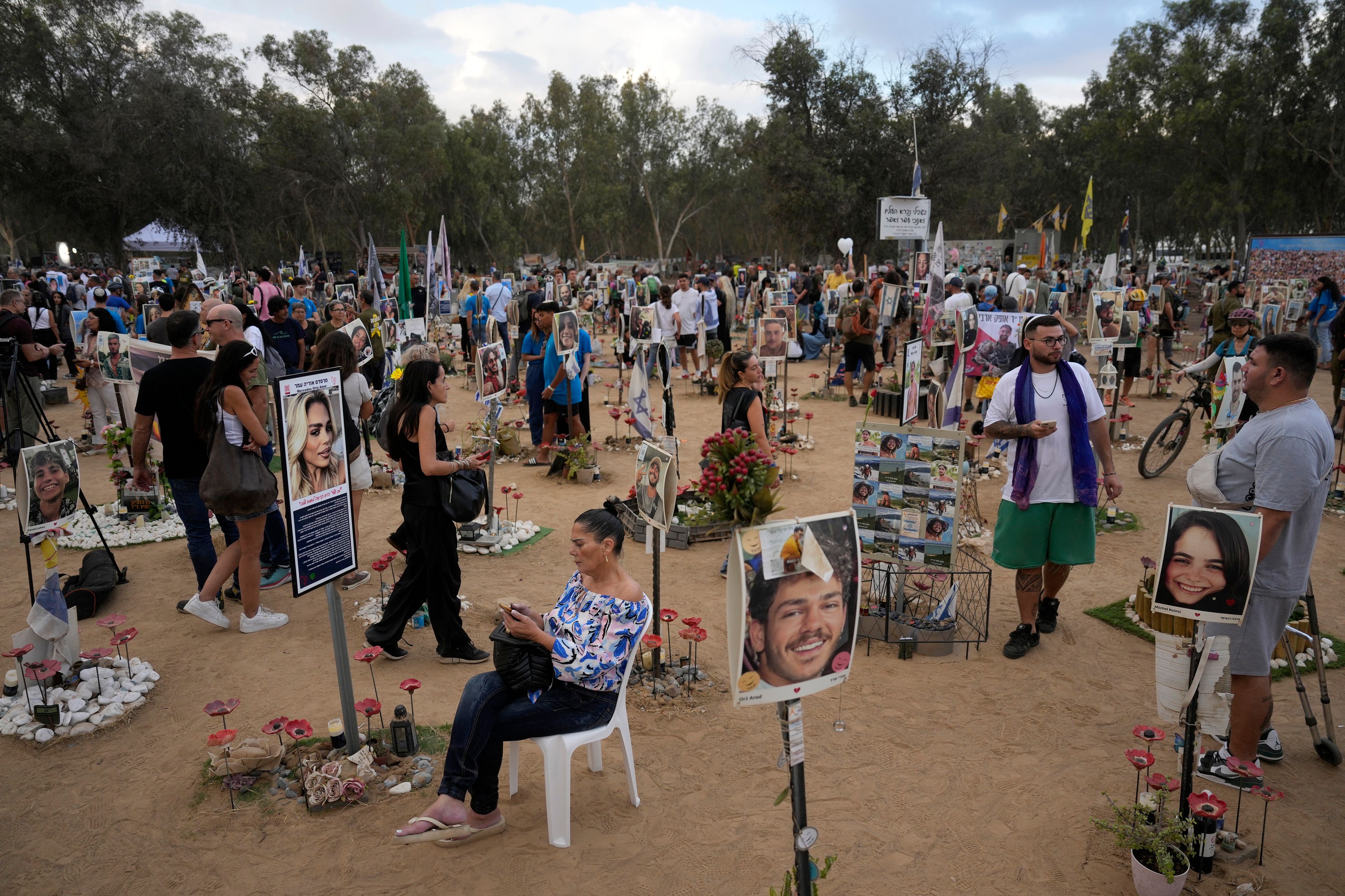 People visit the site of the Nova music festival, where hundreds of revelers were killed and abducted by Hamas and taken into Gaza, on the one-year anniversary of the attack, near Kibbutz Reim, southern Israel, Monday, Oct. 7, 2024. (AP Photo/Ariel Schalit)