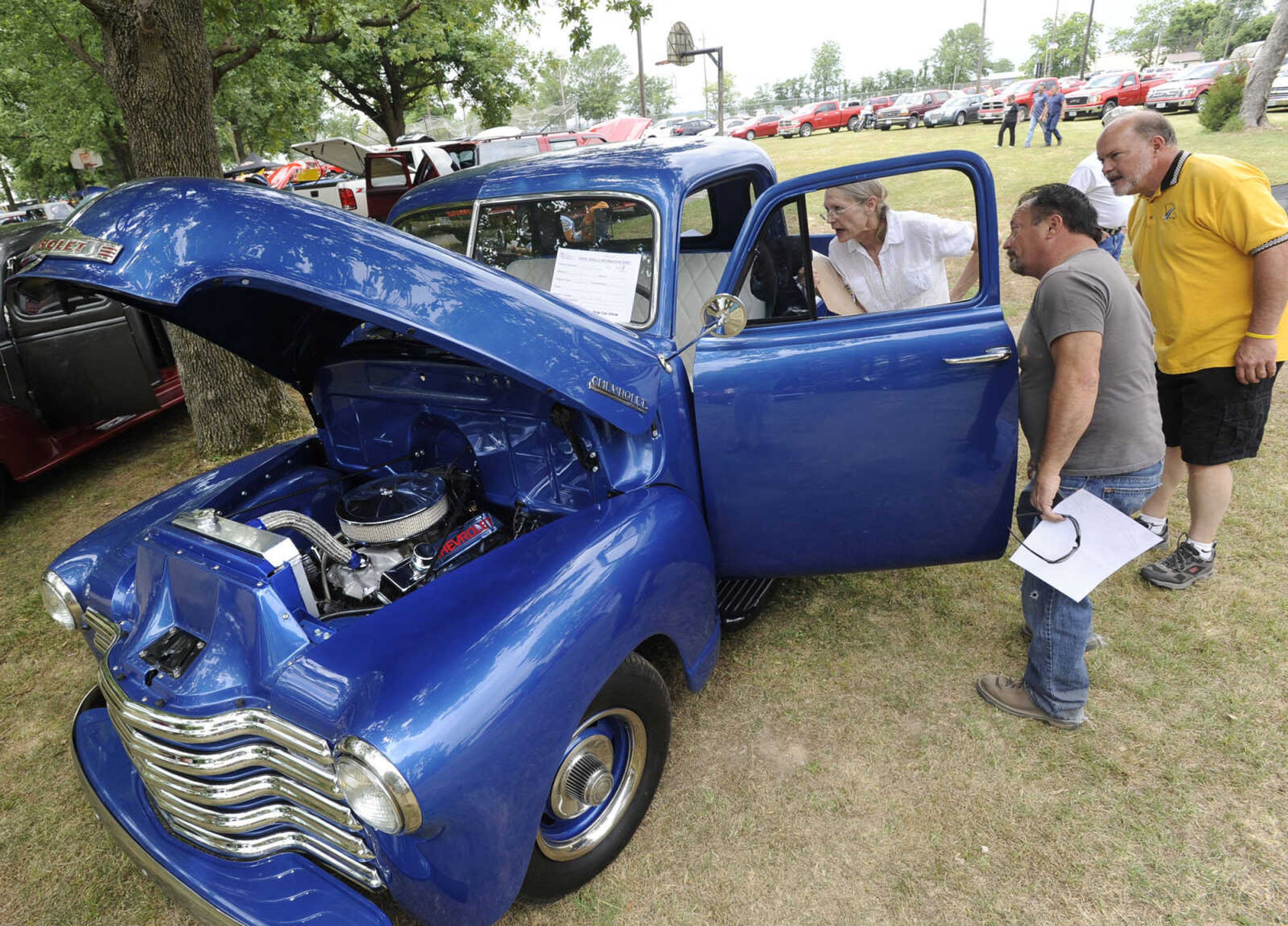 A 1951 Chevy pickup owned by Gary Massey is judged by Rhonda Tidwell, David Carnell and Gary Wibbenmeyer at the Oran Car Show.