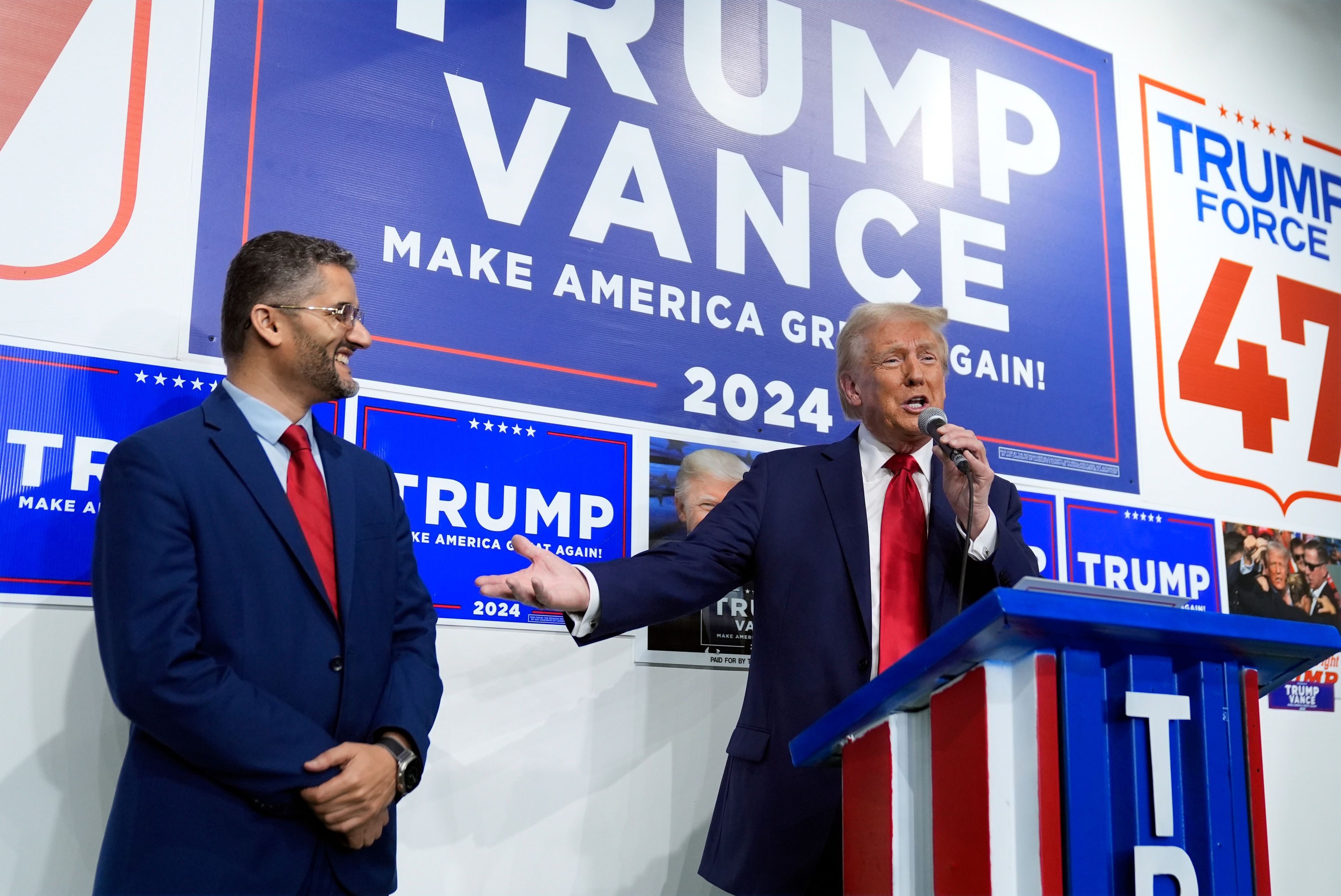 Republican presidential nominee former President Donald Trump speaks as Hamtramck Mayor Amer Ghalib listens at a campaign office, Friday, Oct. 18, 2024, in Hamtramck, Mich. (AP Photo/Evan Vucci)