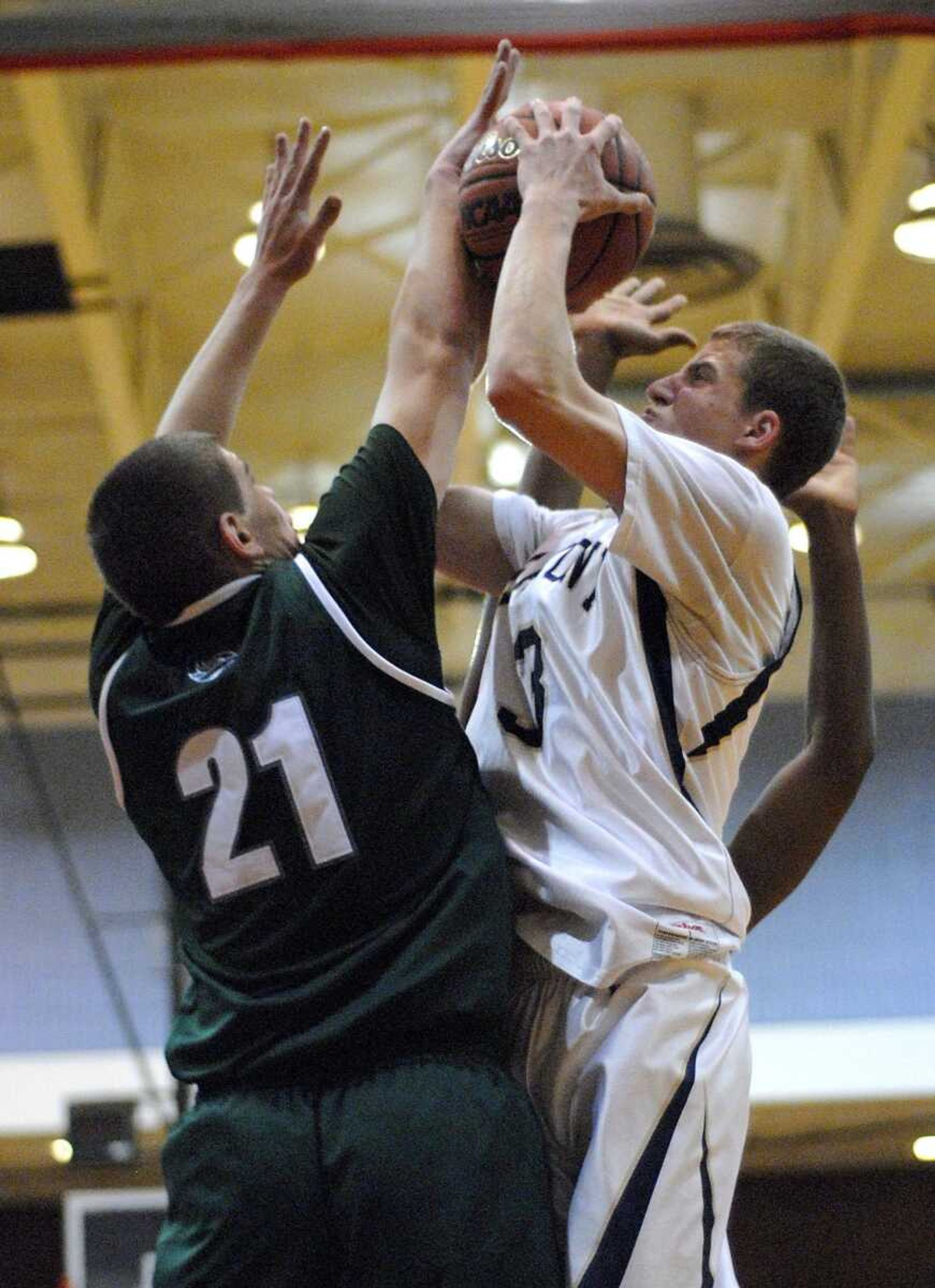 Saxony Lutheran's Brayton Klaus takes a shot over Bayless' Taylor Johnson during the second quarter of a MSHSAA Class 3 sectional game at Jefferson College in Hillsboro, Mo., on Wednesday, March 9, 2011. Saxony Lutheran lost 63-50. (Kristin Eberts)