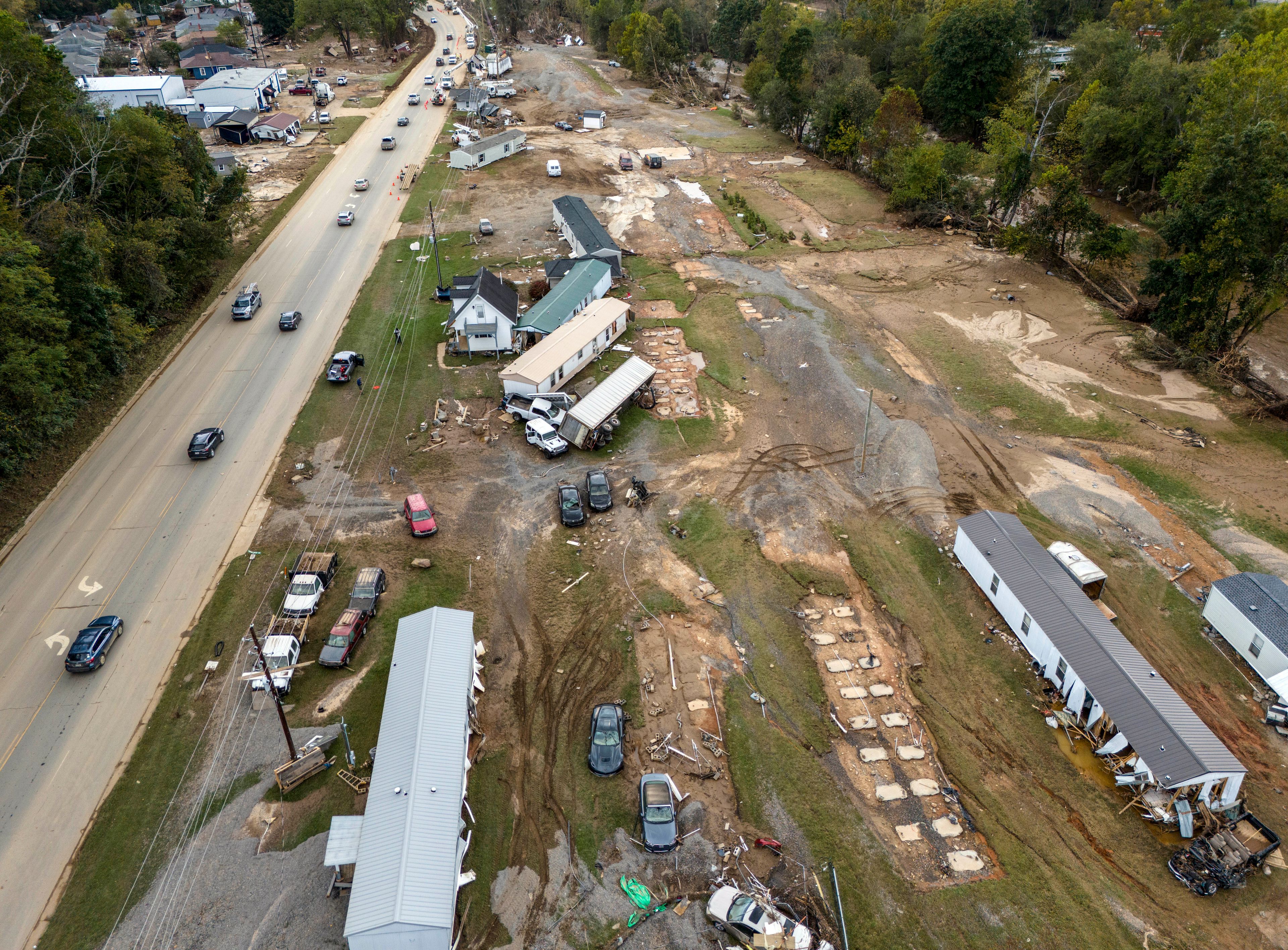 FILE - Homes and vehicles that were damaged in a flash flood from Hurricane Helene lie on the side of a road near the Swannanoa River, Tuesday, Oct. 1, 2024, in Swannanoa, N.C. (AP Photo/Mike Stewart, File)