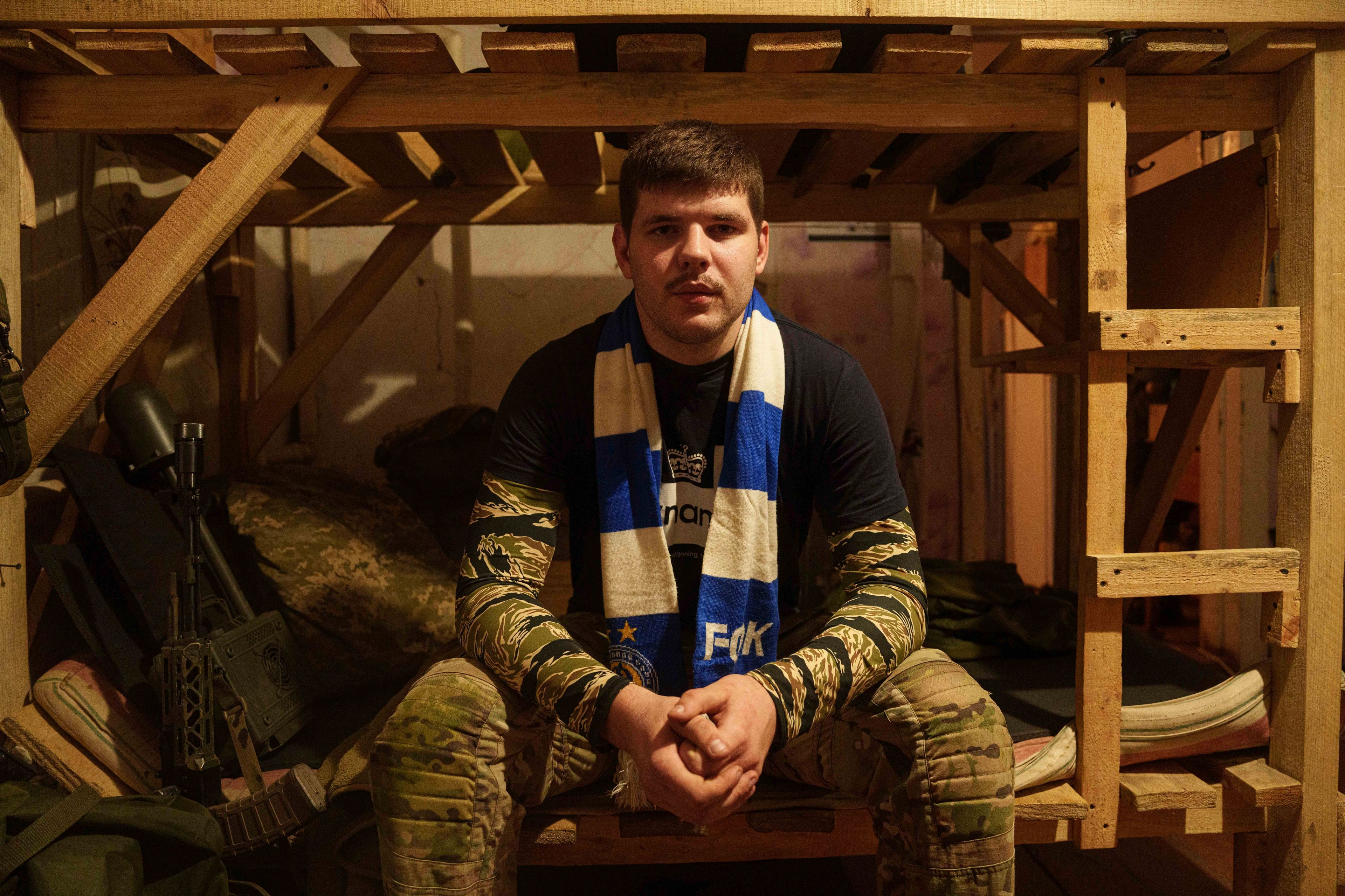 Ukrainian serviceman known by the call sign "Ball" of the 3rd assault brigade sits on a bed not far from the frontline in Kharkiv region, Ukraine, Sunday Sept. 22, 2024. (AP Photo/Evgeniy Maloletka)