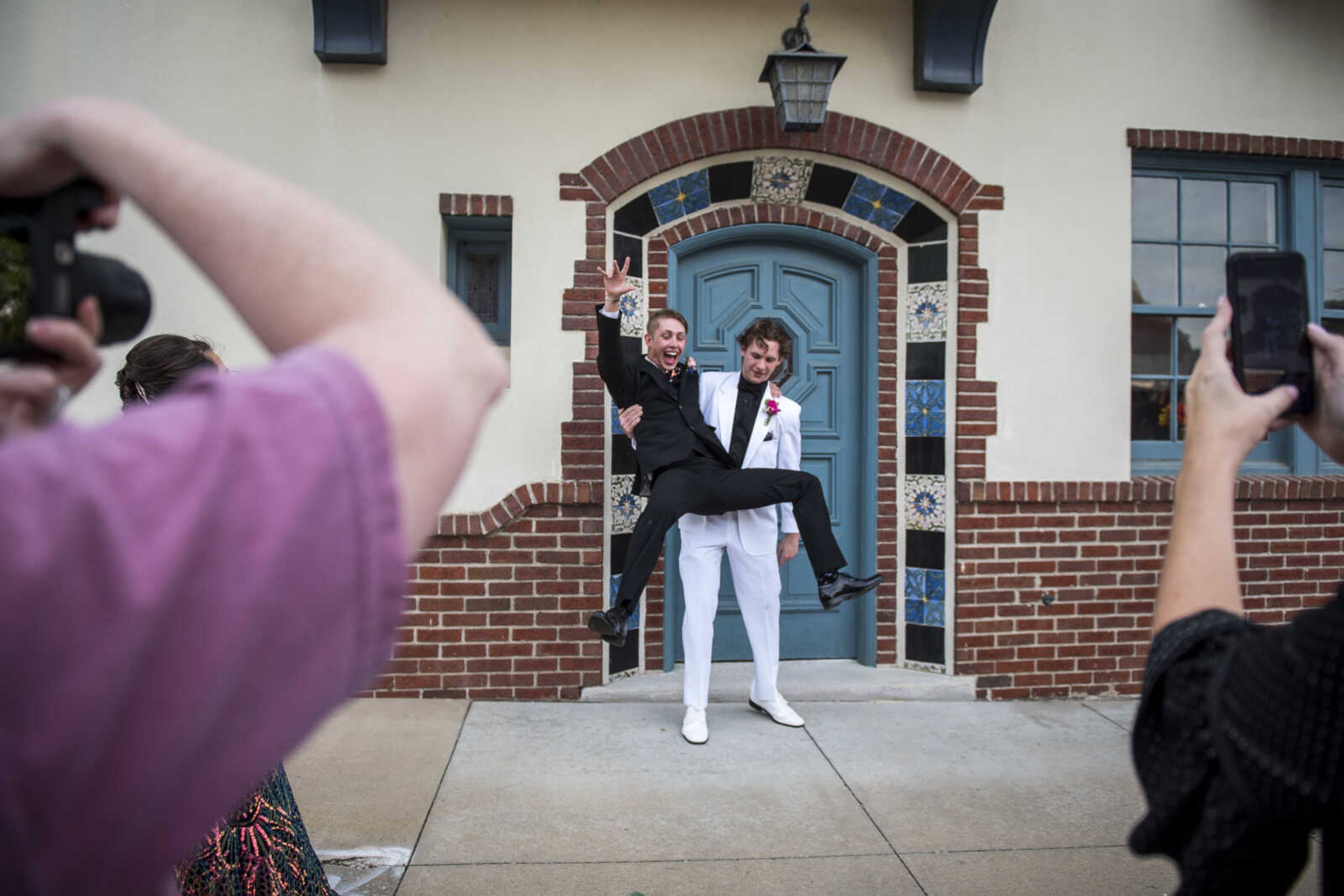 Gavin Jones jumps from Noah Mejean's arms while parents try to take pictures before Cape Central High School Prom Saturday, April 27, 2019, at Ray's Banquet Center in Cape Girardeau.