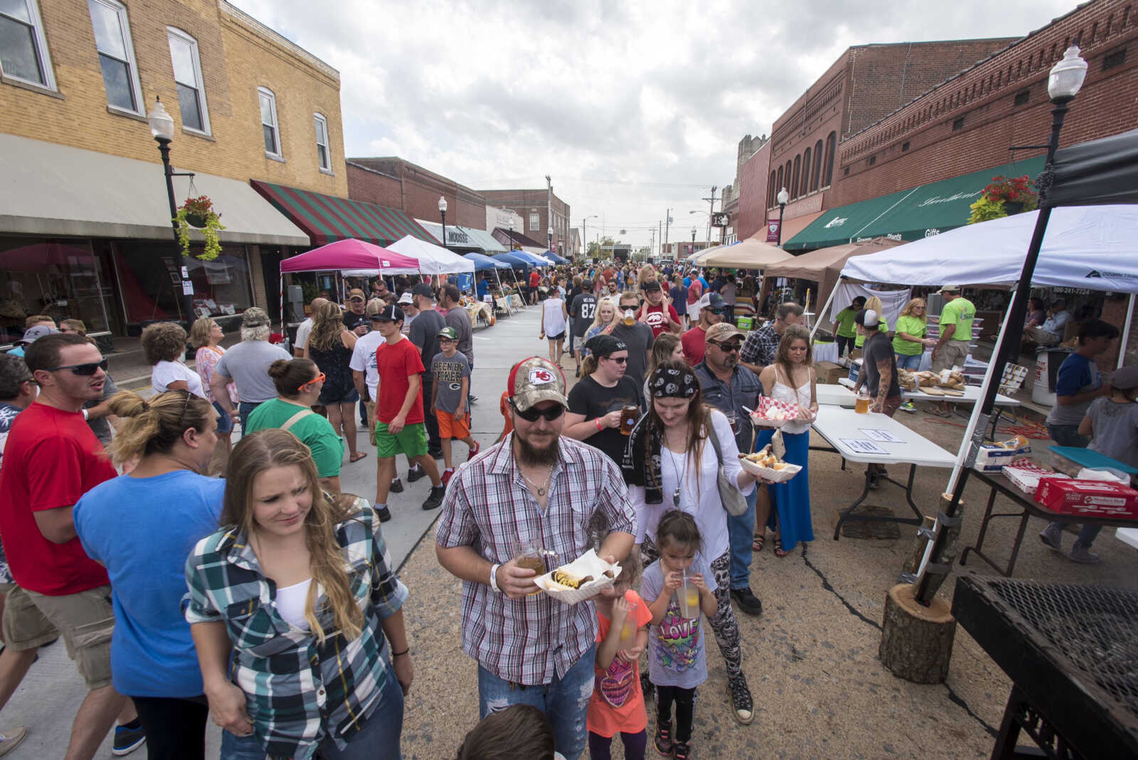 People walk along High Street at the Uptown Jackson Oktoberfest, Saturday, October 7, 2017.