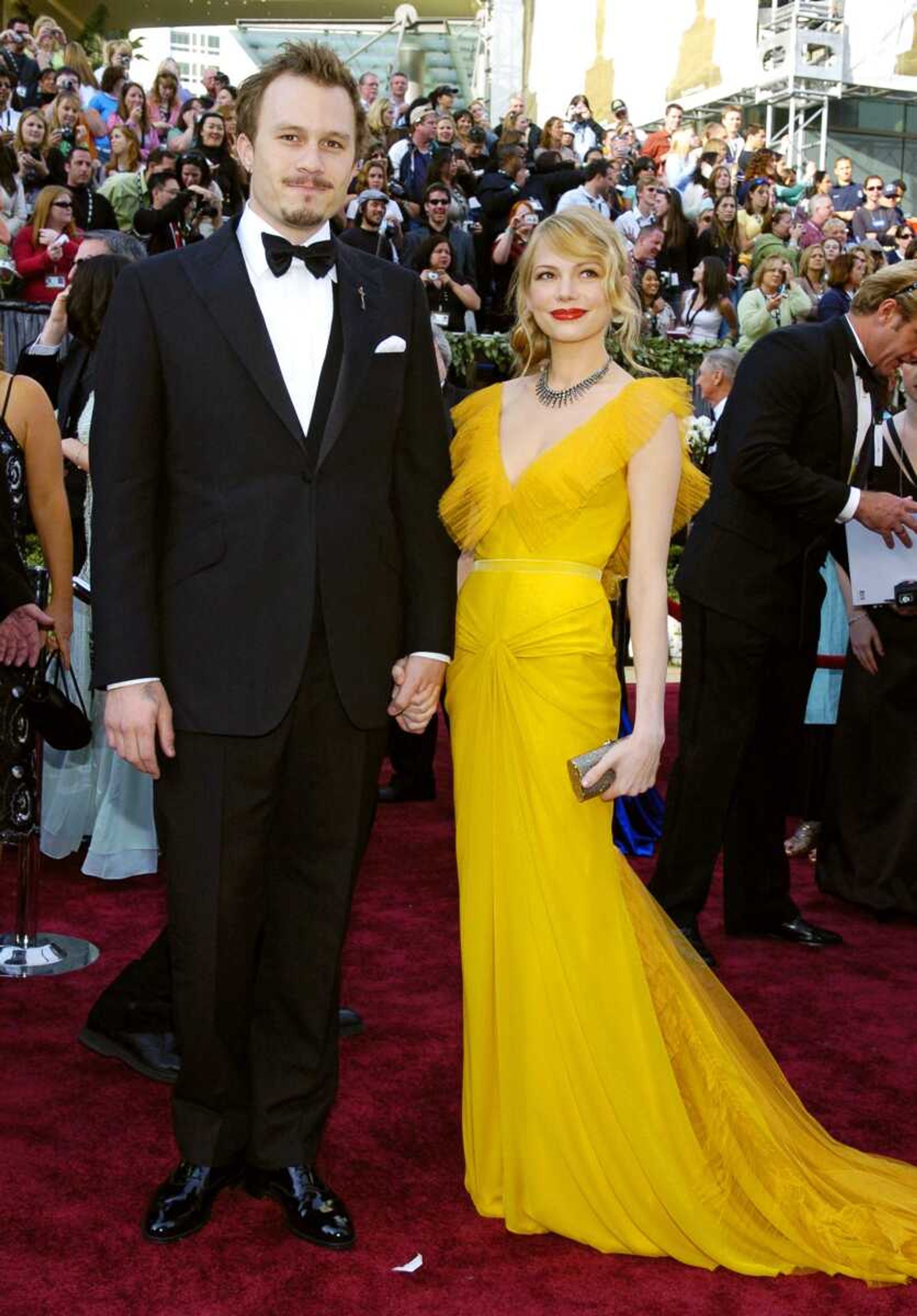 Australian actor Heath Ledger, left, and actress Michelle Williams arrive for the 78th Academy Awards  on March 5, 2006, in Los Angeles. The dress Williams wore is considered one of the top red-carpet looks of all time and is included in a new book, "The Looks of Love: 50 Moments in Fashion that Inspired Romance."