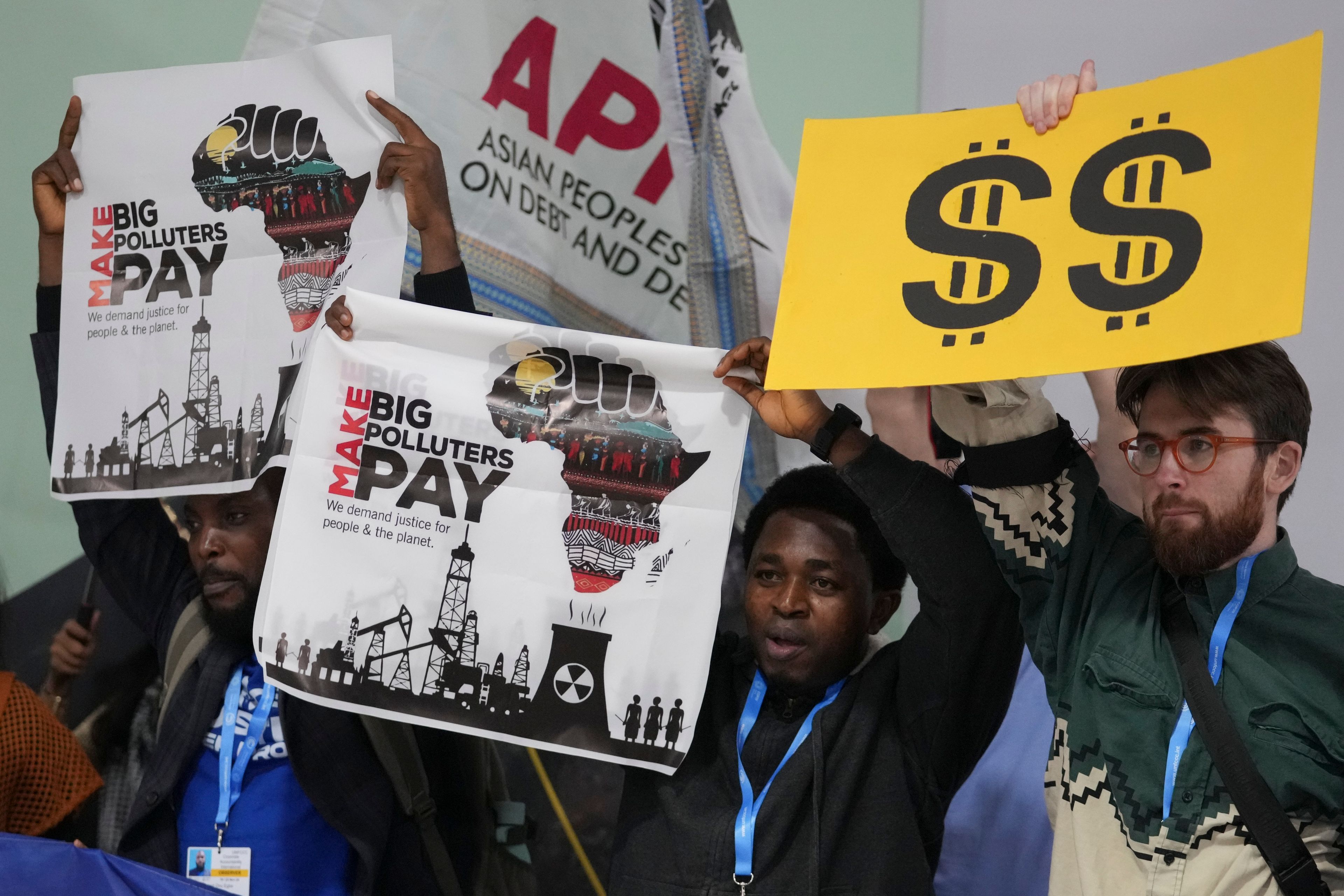 Activists participate in a demonstration for climate finance at the COP29 U.N. Climate Summit, Tuesday, Nov. 19, 2024, in Baku, Azerbaijan. (AP Photo/Sergei Grits)