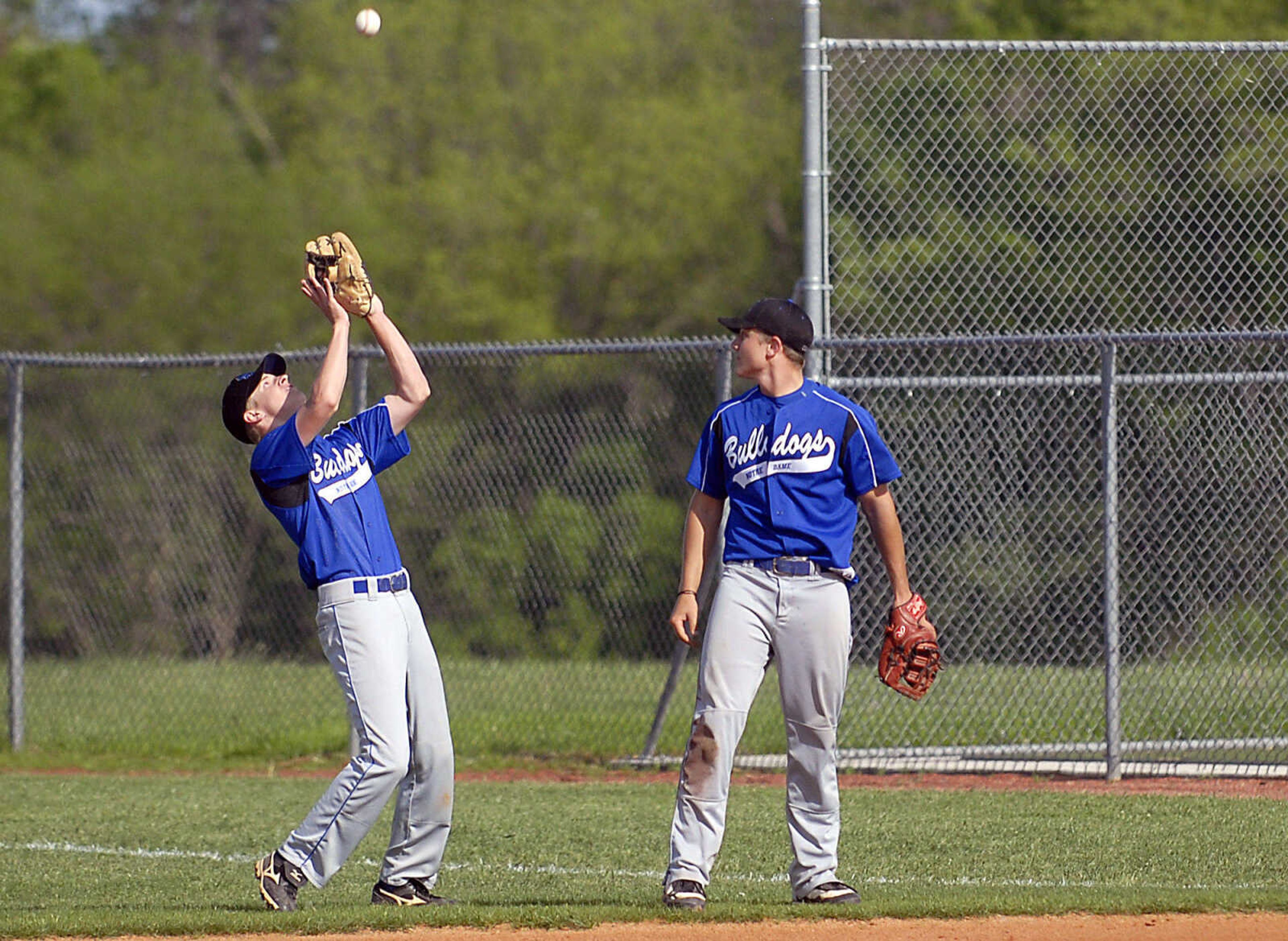 Bulldogs first baseman Wesley Glaus watches as second baseman Ethan Essner sets up under a pop fly Tuesday, April 28, 2009, against Sikeston in Cape Girardeau.