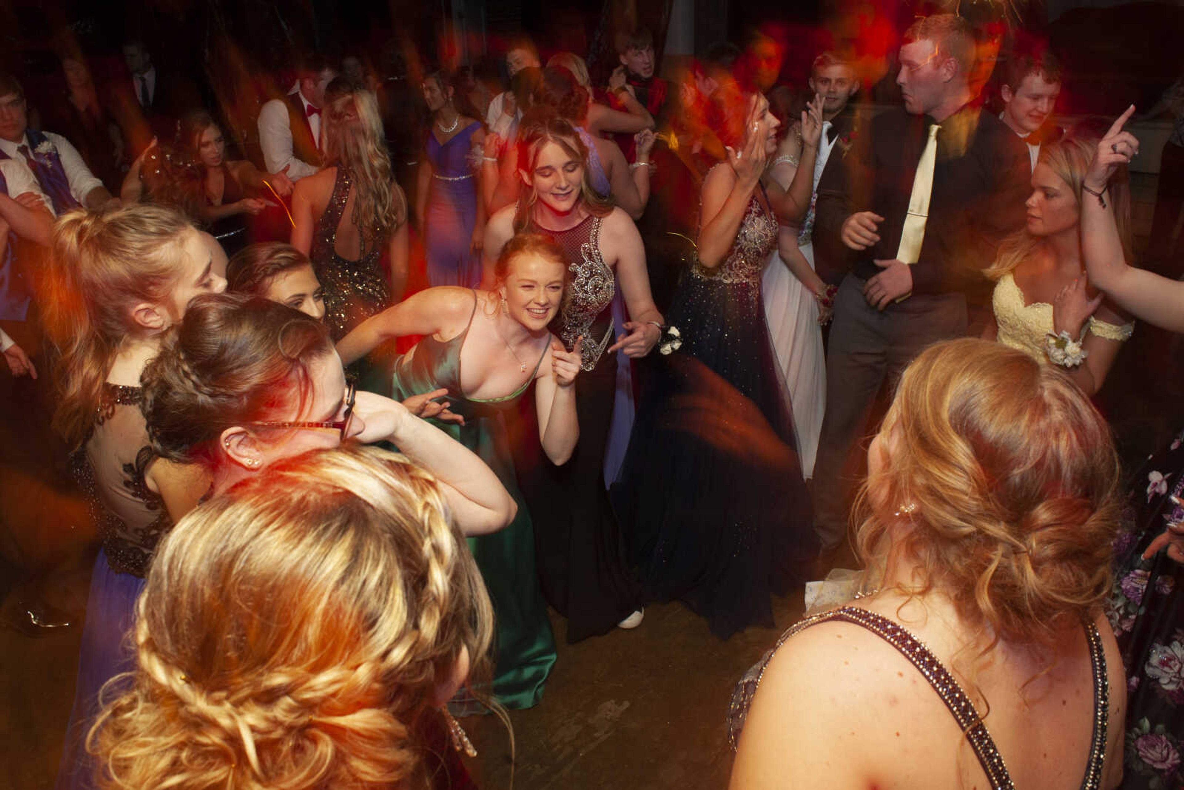 Leopold senior Patience VanderMierden, center, points while dancing during Leopold High School's "Masquerade at Midnight" prom Saturday, April 27, 2019, in Leopold.