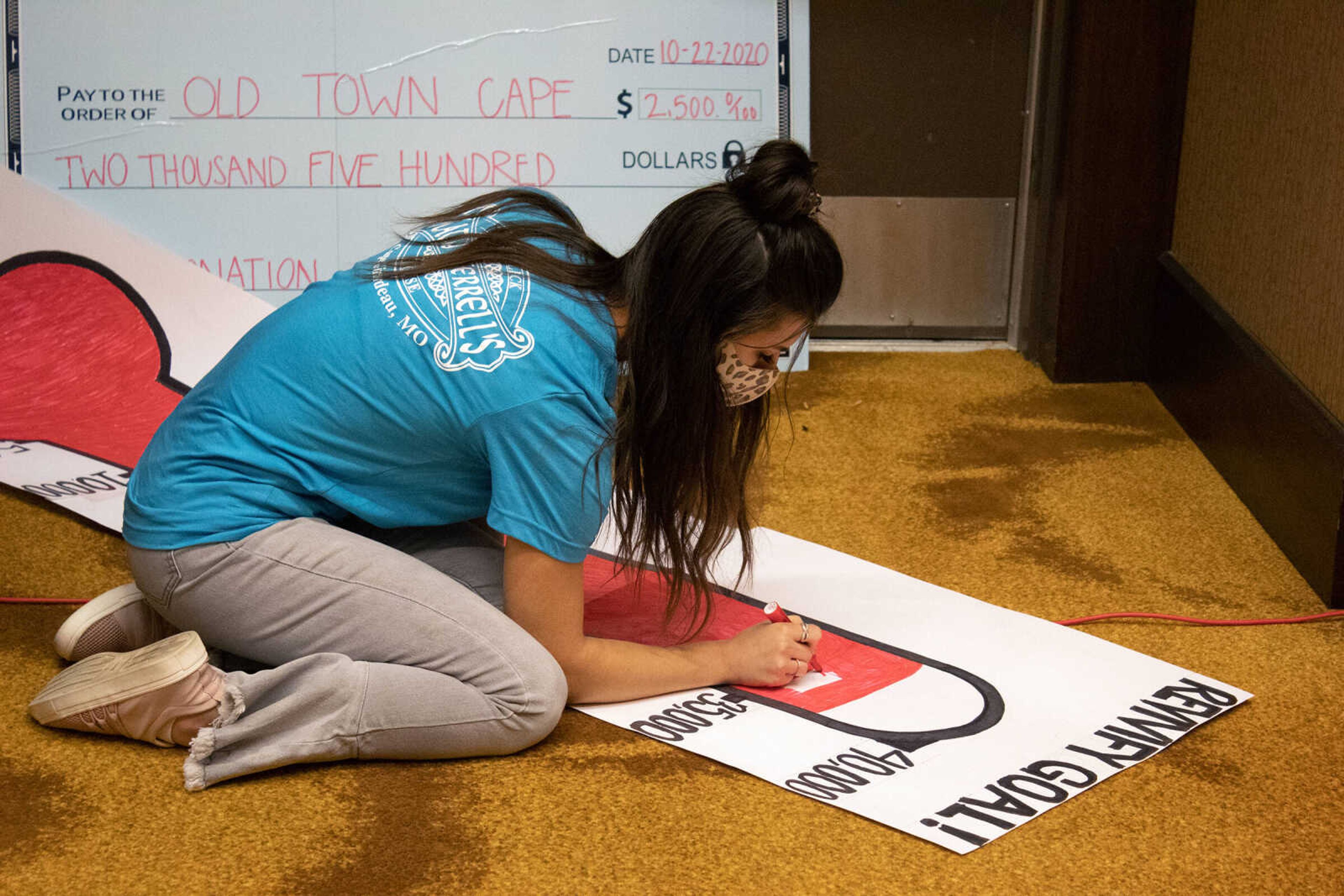 SEMO student and Revivify volunteer Madelyn Brown updates the fundraising goal chart as money is raised at Old Town Cape's Revivify fundraiser on Thursday, Oct. 22, 2020, at Century Casino in Cape Girardeau.