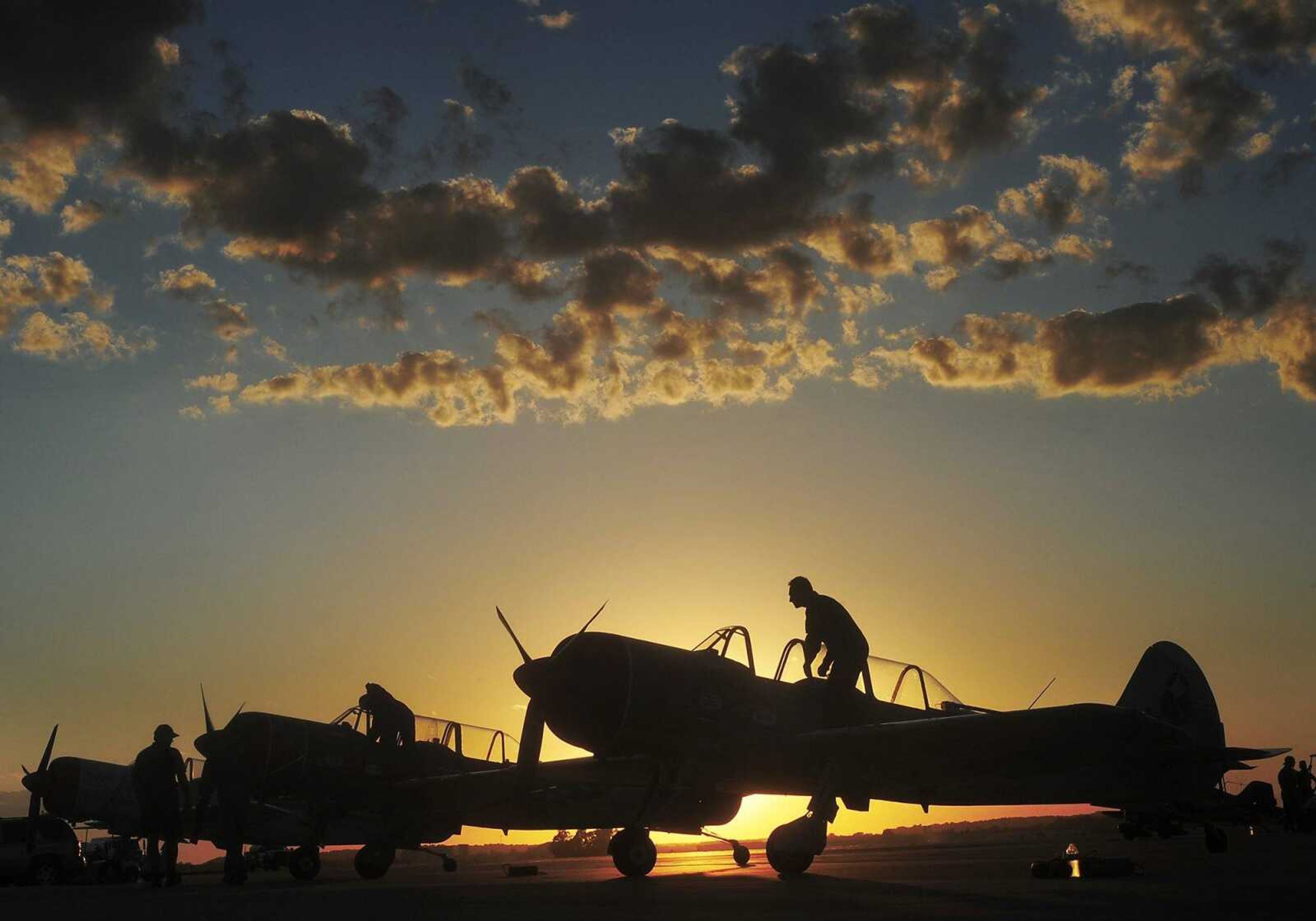 ADAM VOGLER ~ avogler@semissourian.com
The Aerostars precision aerobatic team board their Yak 52 TW aircraft before their performance at the Cape Girardeau Regional Air Festival Friday, June 28, 2013, at the Cape Girardeau Regional Airport. The World War II era aerobatic trainer, designed by the former Soviet Union, was built in Romania and are powered by a 400 horsepower supercharged radial engine.