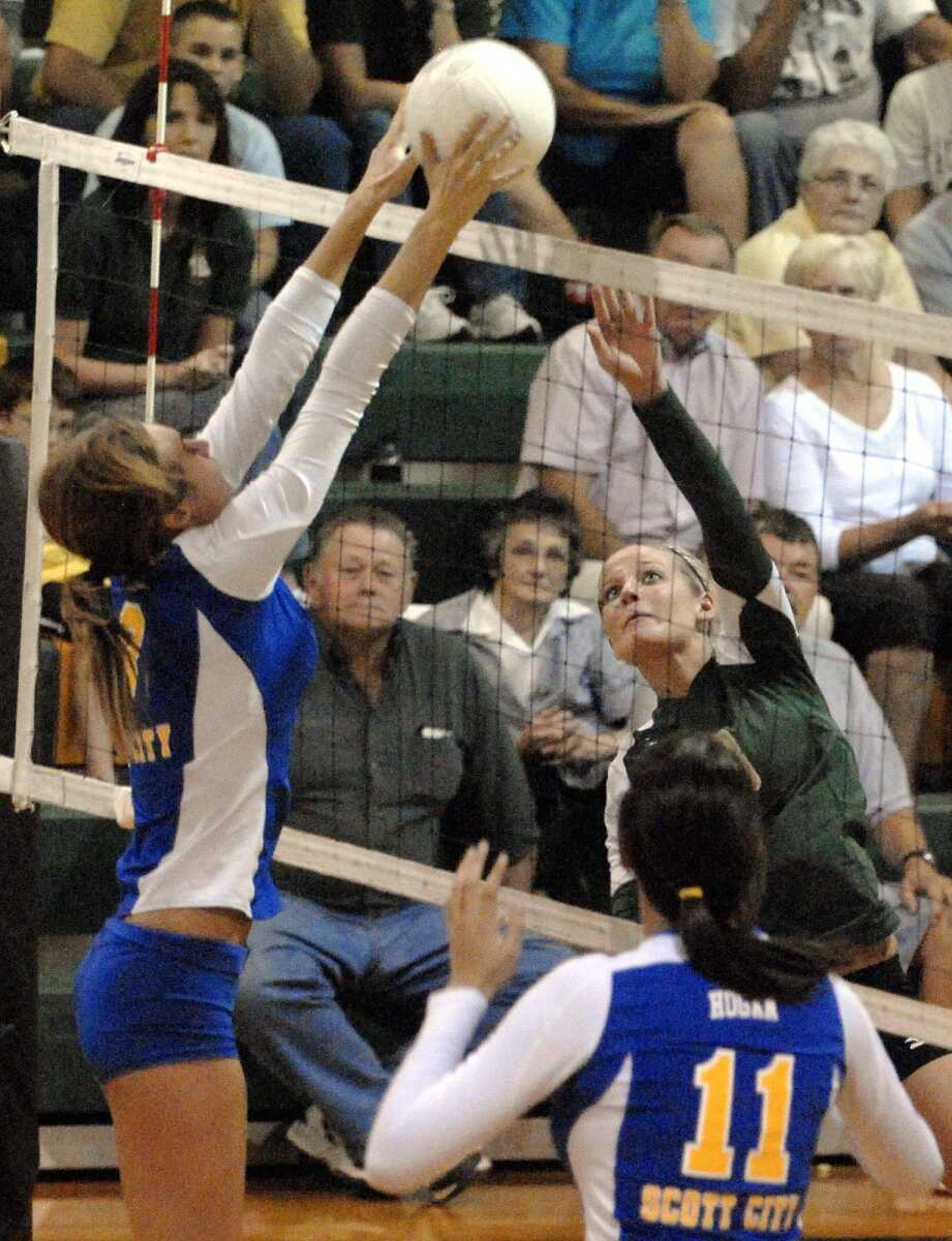 Scott City's Whitney Froman, left, blocks a shot from Zalma senior Torie VanGennip for a point during Game 2 of their match Monday in Zalma, Mo. (Laura Simon)