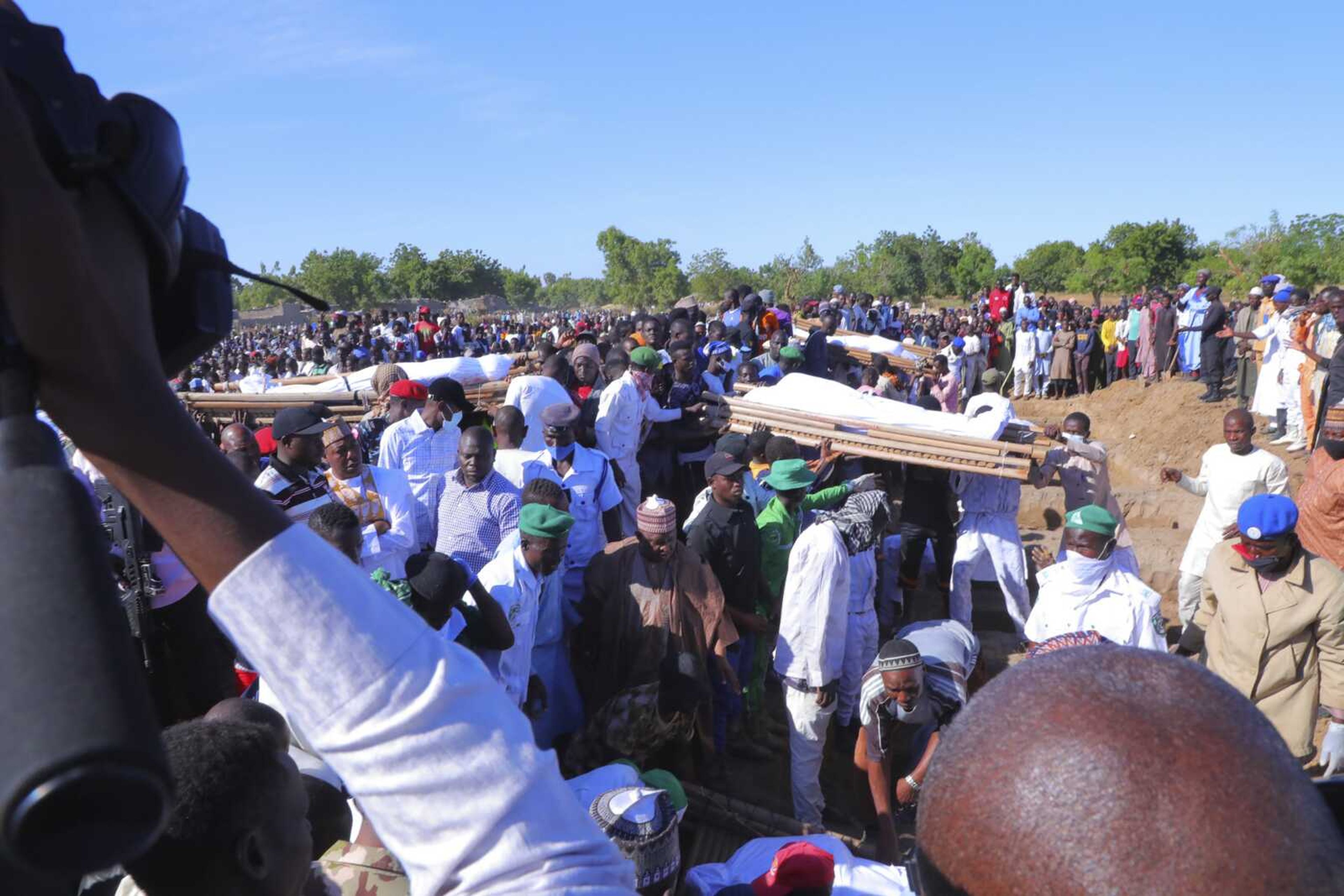 Funeral for victims of rice farmers and fishermen who were killed Saturday by suspected Boko Haram are seen Sunday in Zaabarmar, Borno, Nigeria.