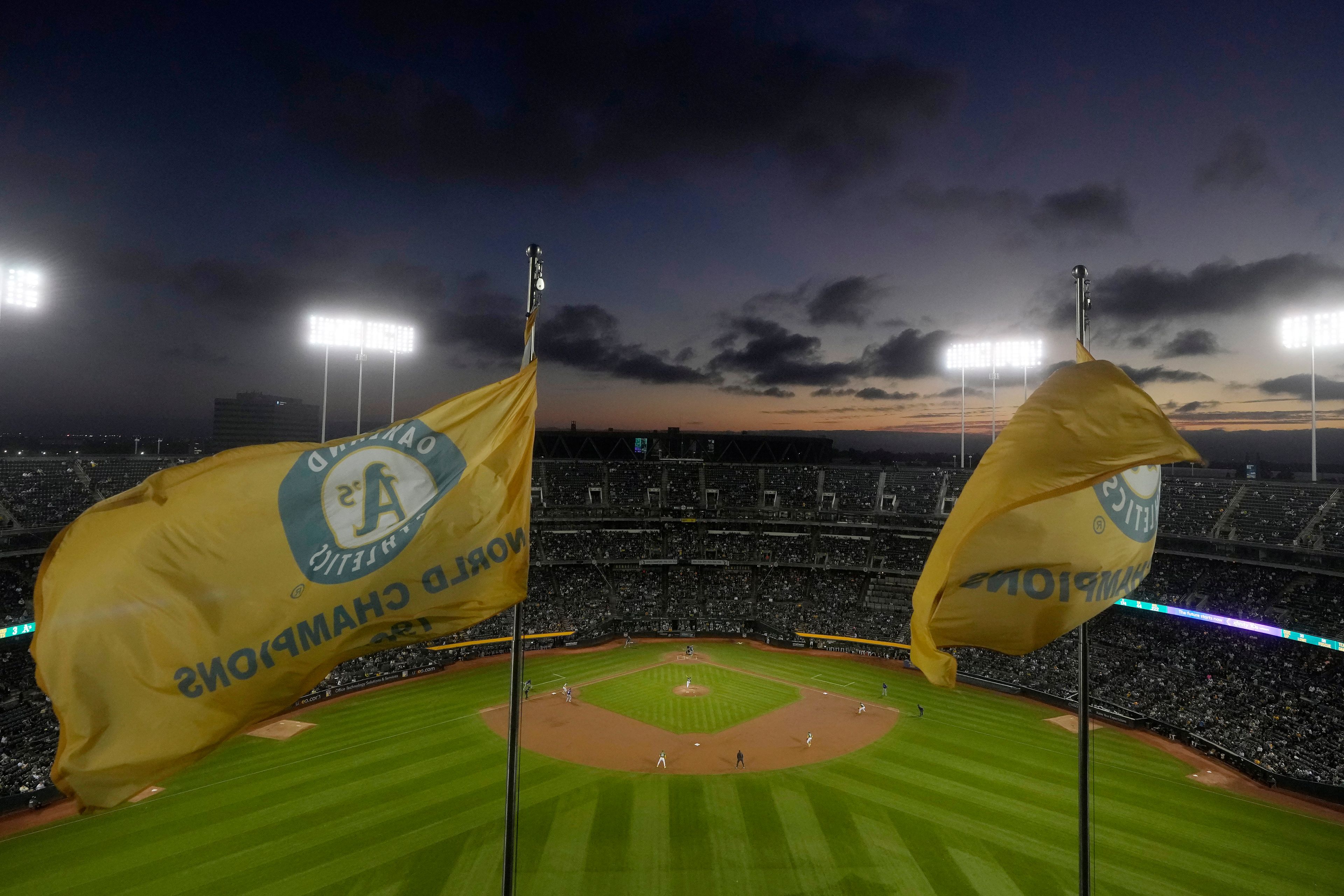 Fans at the Oakland Coliseum watch during the third inning of a baseball game between the Oakland Athletics and the Texas Rangers in Oakland, Calif., Wednesday, Sept. 25, 2024. (AP Photo/Jeff Chiu)