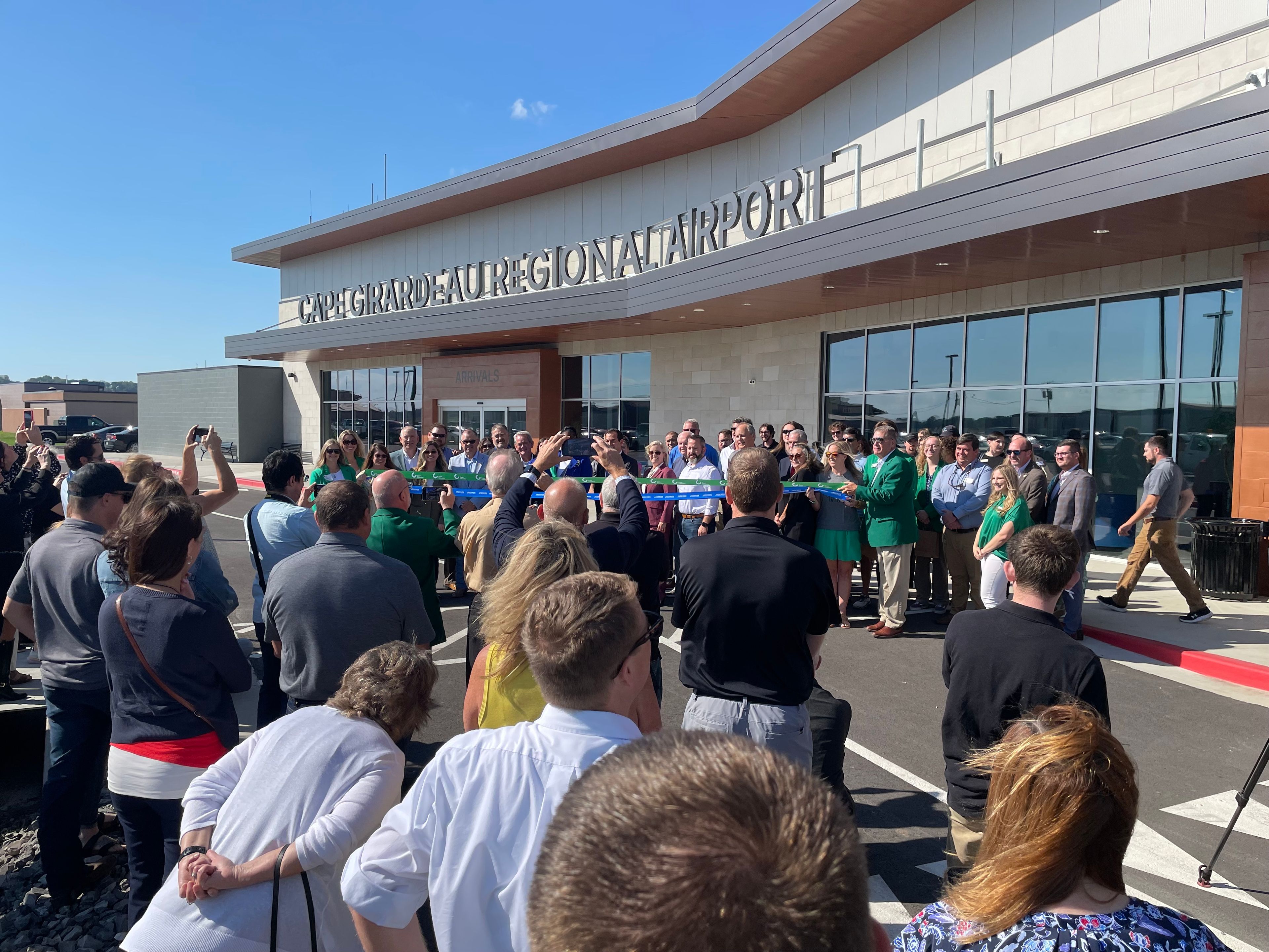 Airport, city and chamber officials prepare to the cut the ribbon on the opening of the new airport terminal in Cape Girardeau.