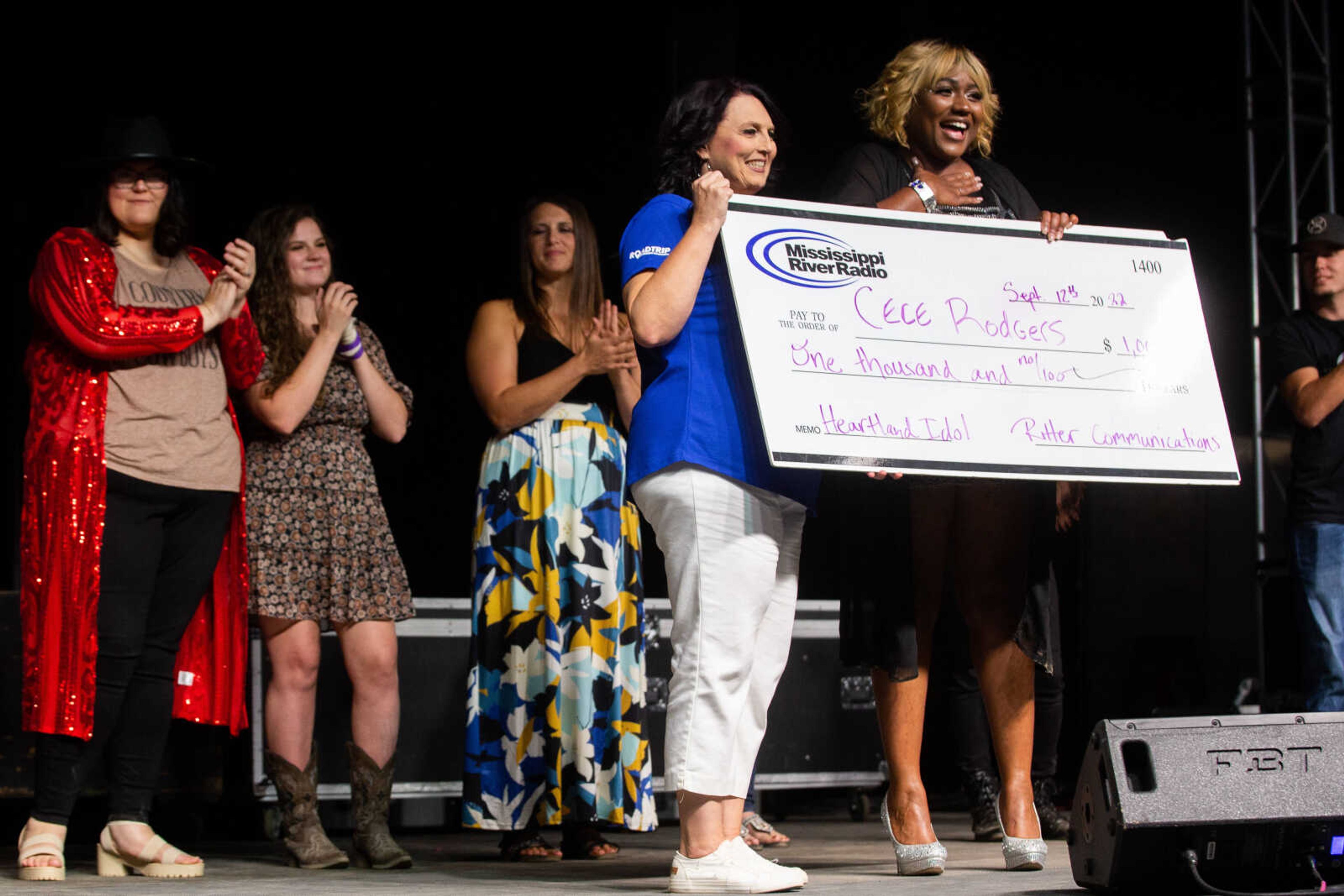 Cece Rodgers holds the competition prize, a check for $1,000, as she  wins the title "2022 Heartland Idol" on Monday, Sept. 12 in Cape Girardeau.