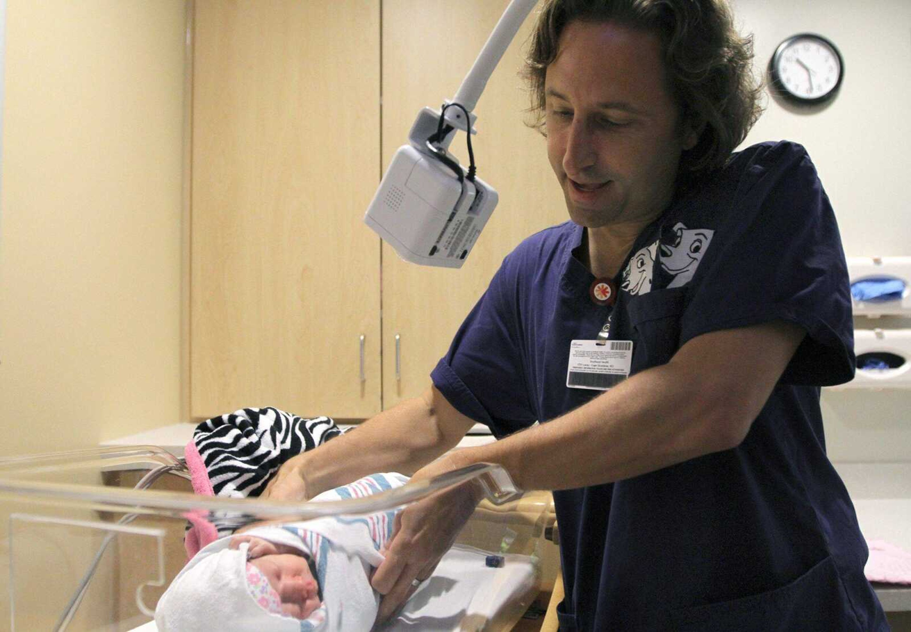 Dr. Paul Caruso checks on Ameila Grace Williams at the Southeast Hospital NICU. (GLENN LANDBERG)