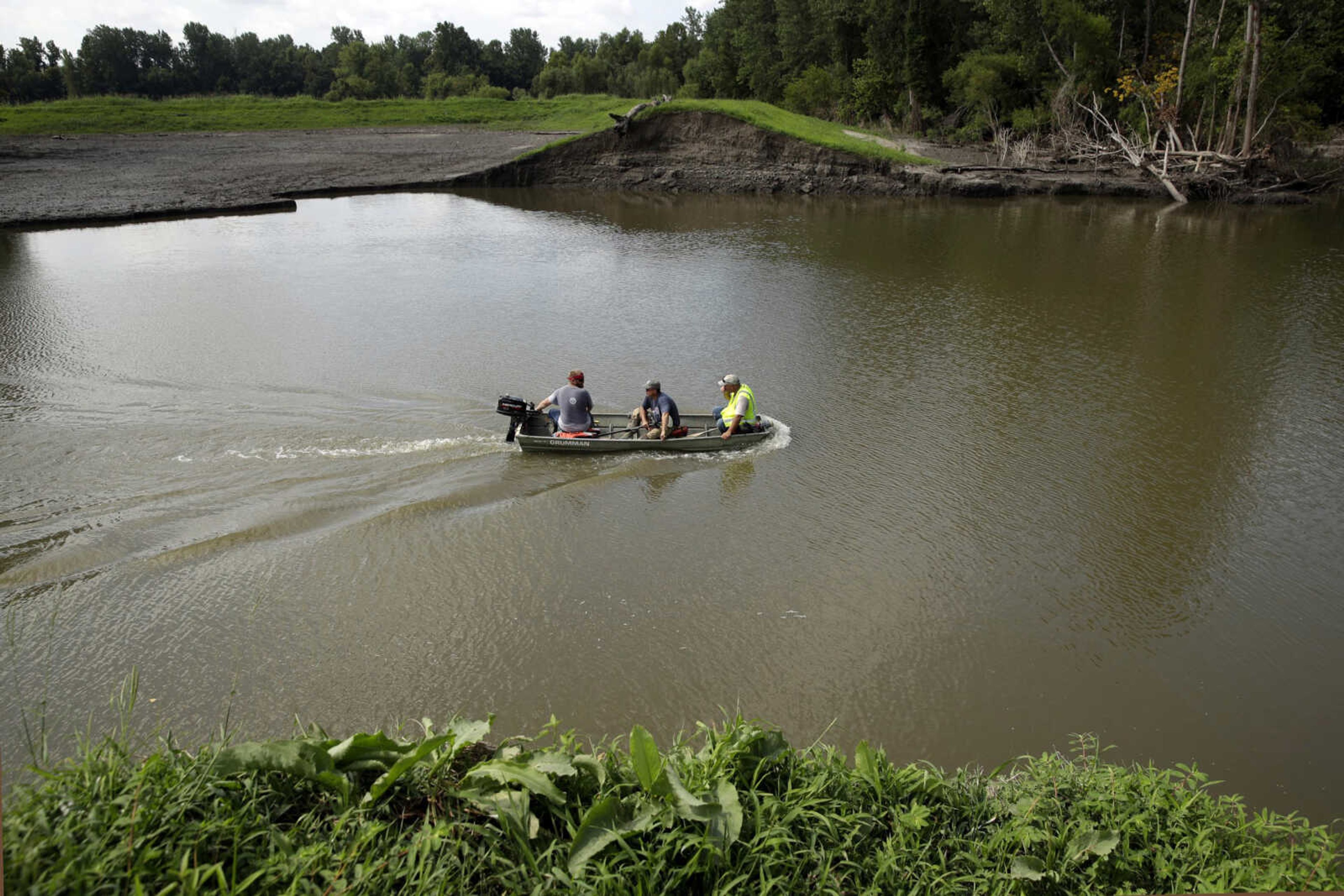 A survey crew for the U.S. Army Corps of Engineers crosses 20-foot-deep flood waters that remain Tuesday after a levee failed along the Missouri River near Saline City, Missouri. The Corps of Engineers estimates it will cost $1 billion to repair flood damaged levees in the Missouri River basin alone.