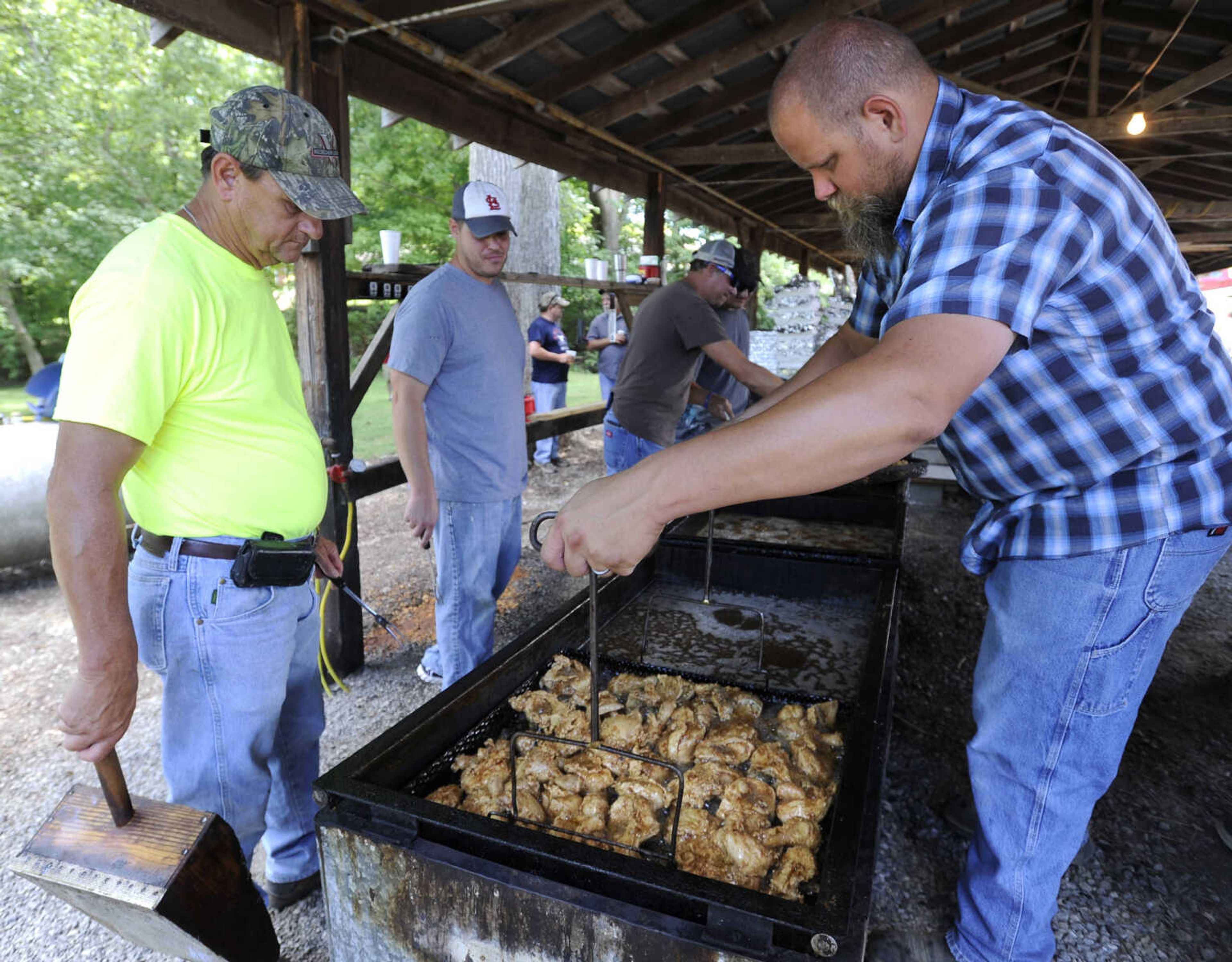 FRED LYNCH ~ flynch@semissourian.com
Ashton James removes fried chicken from the vat as Ronnie Wesbecher watches on Saturday, July 29, 2017 at the St. John's Church Picnic in Leopold, Missouri.