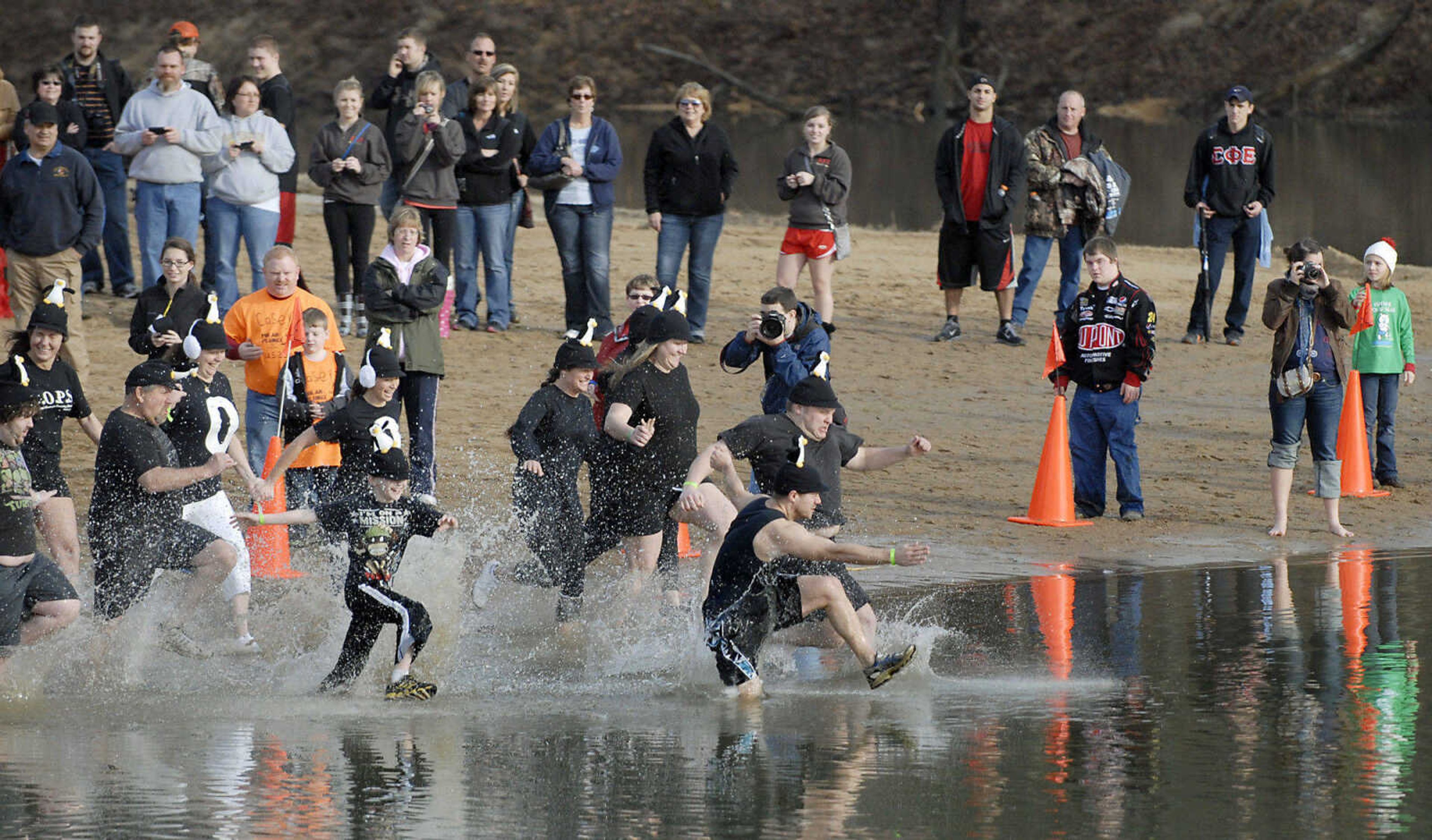 KRISTIN EBERTS ~ keberts@semissourian.com

The Piedmont Penguins team charges into the water during the 2012 Polar Plunge at the Trail of Tears State Park's Lake Boutin on Saturday, Feb. 4, 2012.