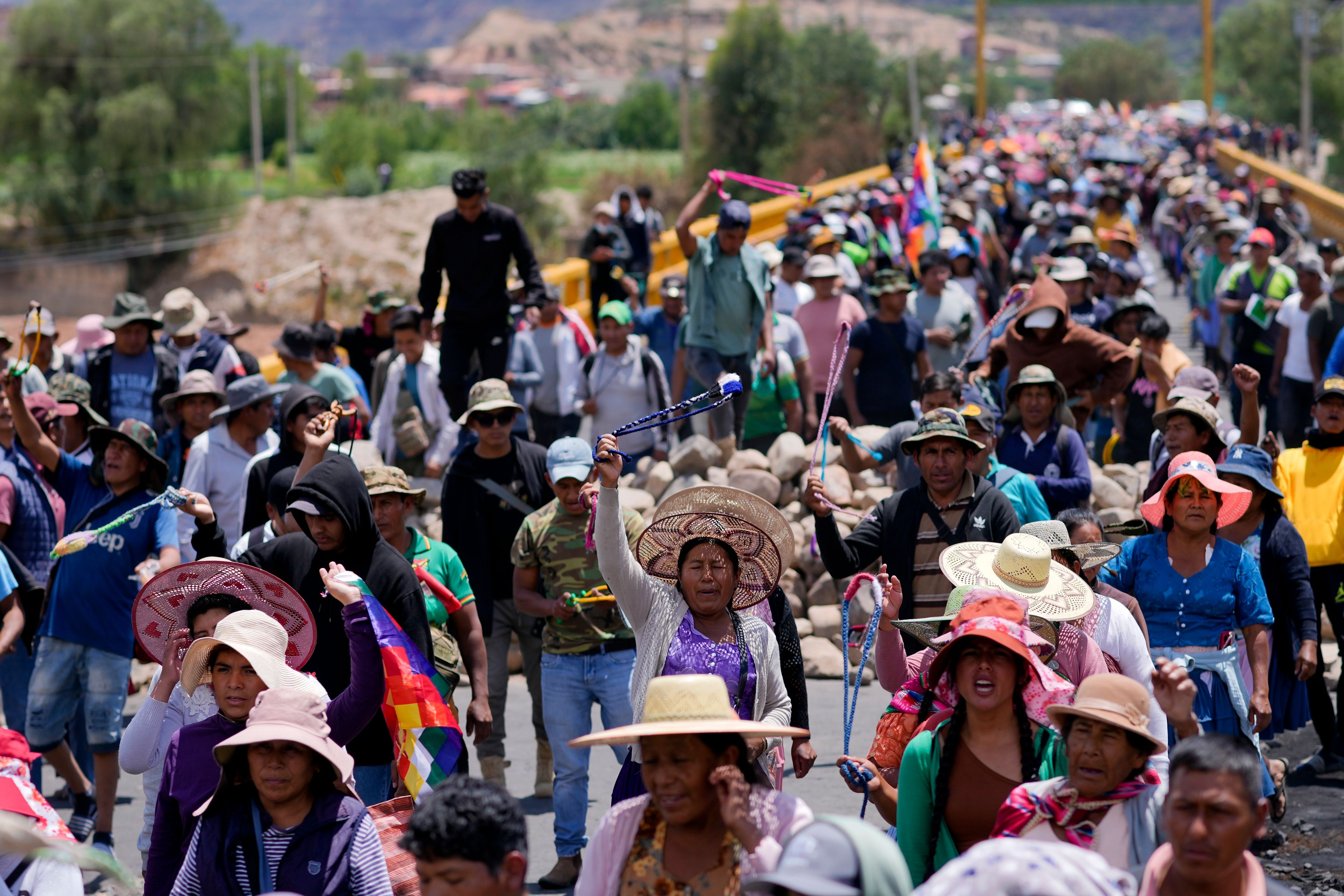 Supporters of Bolivian former President Evo Morales block a road to prevent him from facing a criminal investigation over allegations of abuse of a minor and to demonstrate against an alleged assassination attempt, in Parotani, Bolivia, Tuesday, Oct. 29, 2024. (AP Photo/Juan Karita)