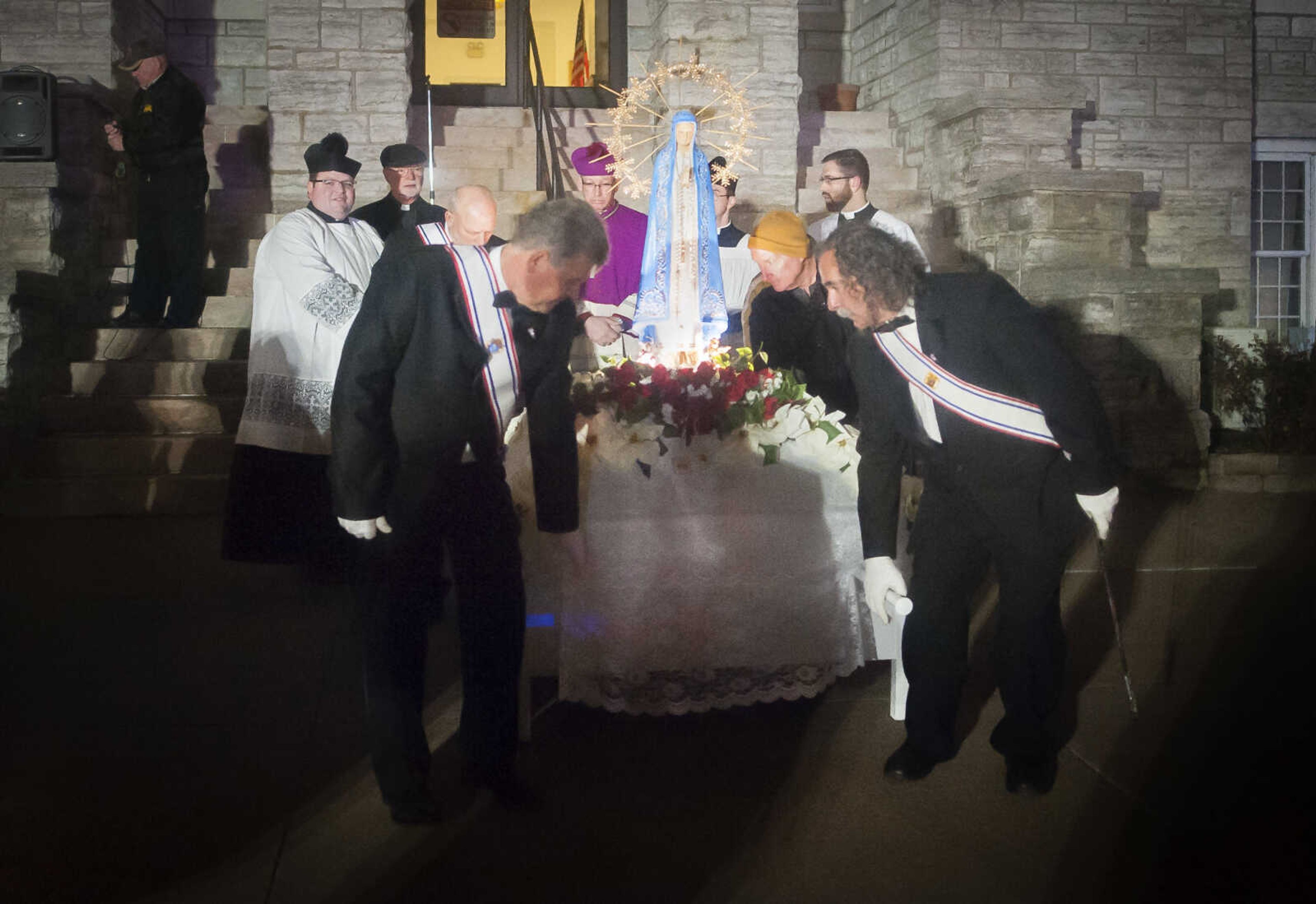 Knights of Columbus members lift a statue of the Virgin Mary to begin a Marian procession Sunday, Dec. 8, 2019, to recognize the church's 170-year anniversary and mark the beginning of the church's capital campaign to build a new church building in Jackson.