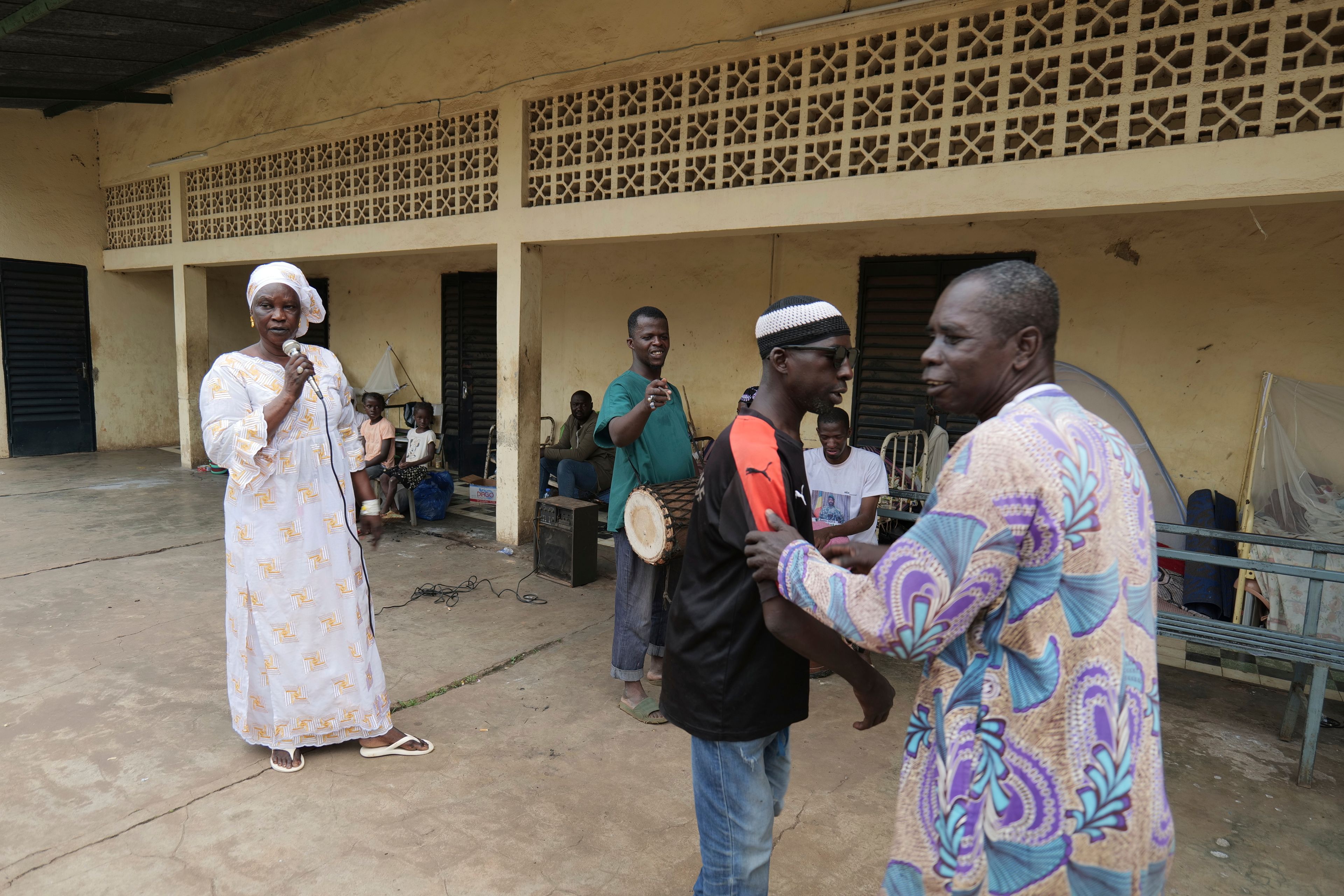 Patients at Bamako's Point G psychiatric ward act out scenes at the psychiatric ward of the Point G hospital in Bamako, Mali, Friday, Sept. 20, 2024. (AP Photo/Moustapha Diallo)