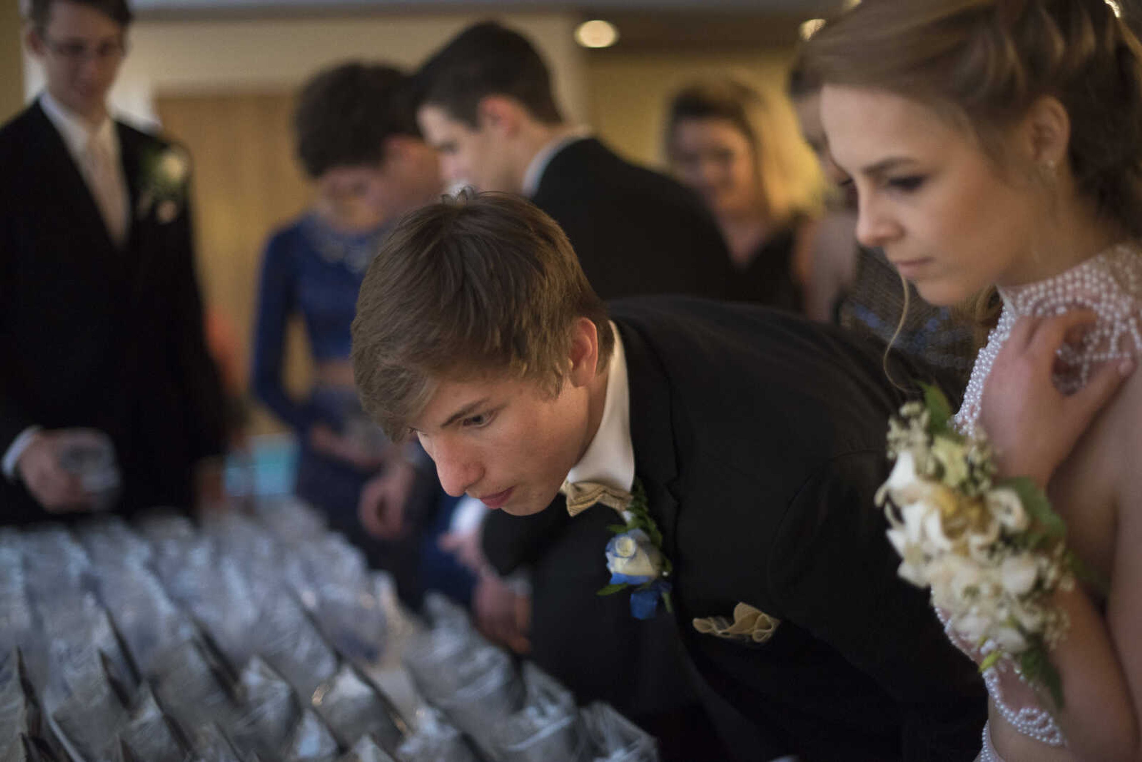 Students look at their prom gifts during the Saxony Lutheran prom Saturday, April 22, 2017 at the Elk's Lodge in Cape Girardeau.