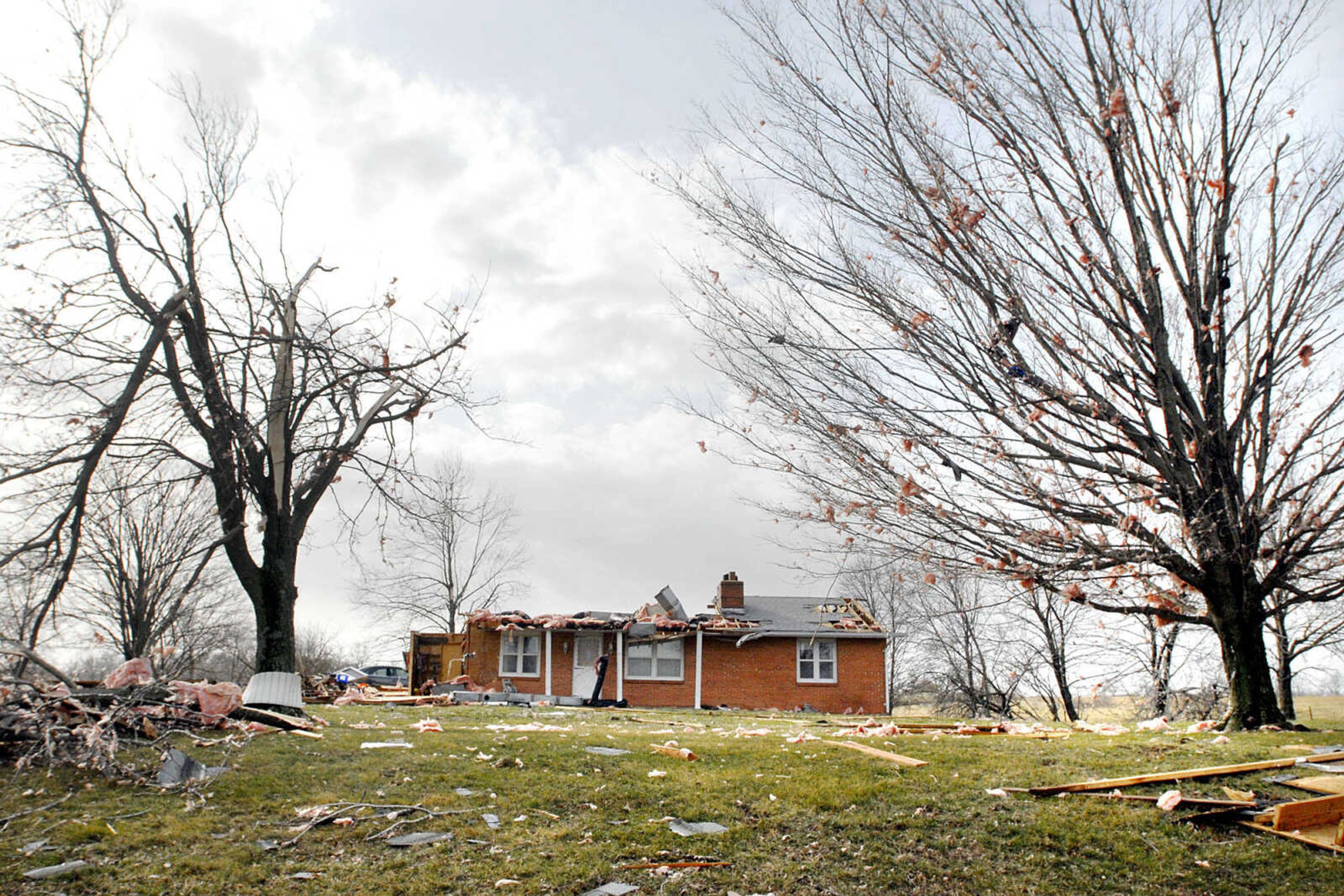 The home of Virgil Mowery, Sr. was heavily damaged leaving insulation and other debris are strewn across the lawn and trees Wednesday, Feb. 29, 2012 after an early morning storm tore through Oak Ridge, Mo. (Laura Simon)