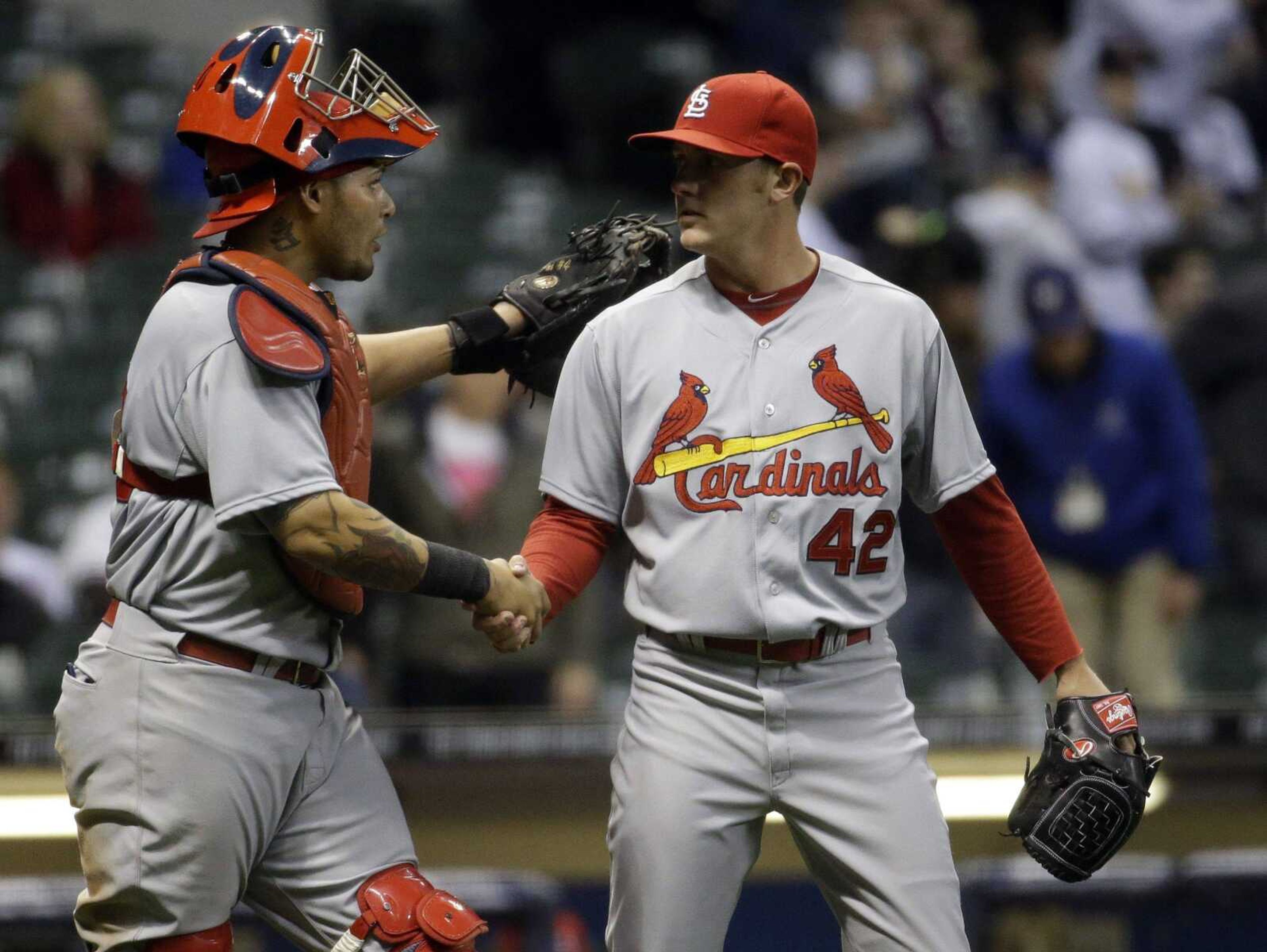 Cardinals&#8217; reliever Seth Maness is congratulated by catcher Yadier Molina after retiring the Brewers in the ninth inning to secure a 6-1 victory in Milwaukee. (Morry Gash ~ Associated Press)