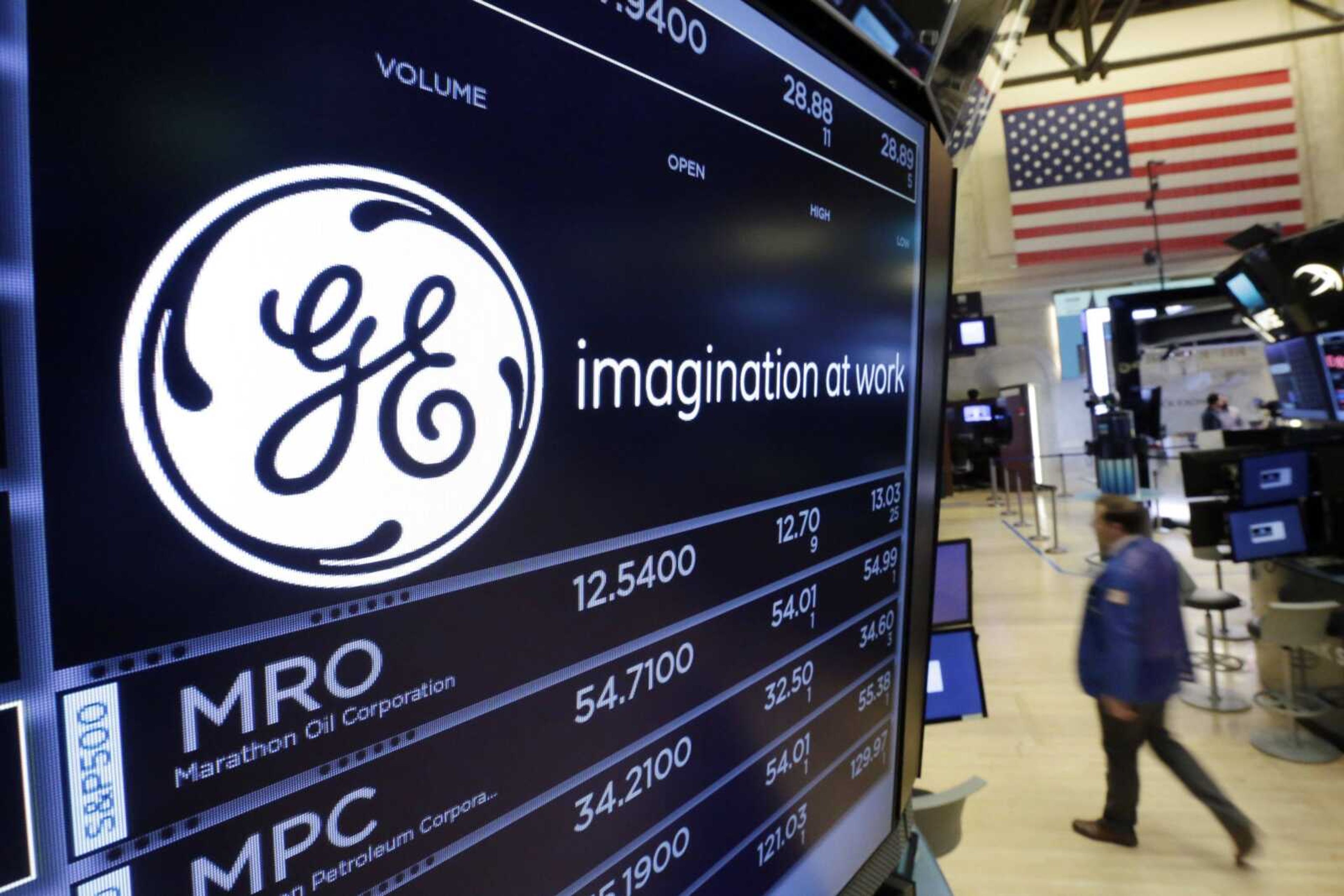 The General Electric logo appears above a trading post on the floor of the New York Stock Exchange. GE said last week it is slashing its quarterly dividend in half with investors gathering in Boston, where chairman and CEO John Flannery is expected to lay out significant changes for the U.S. company.