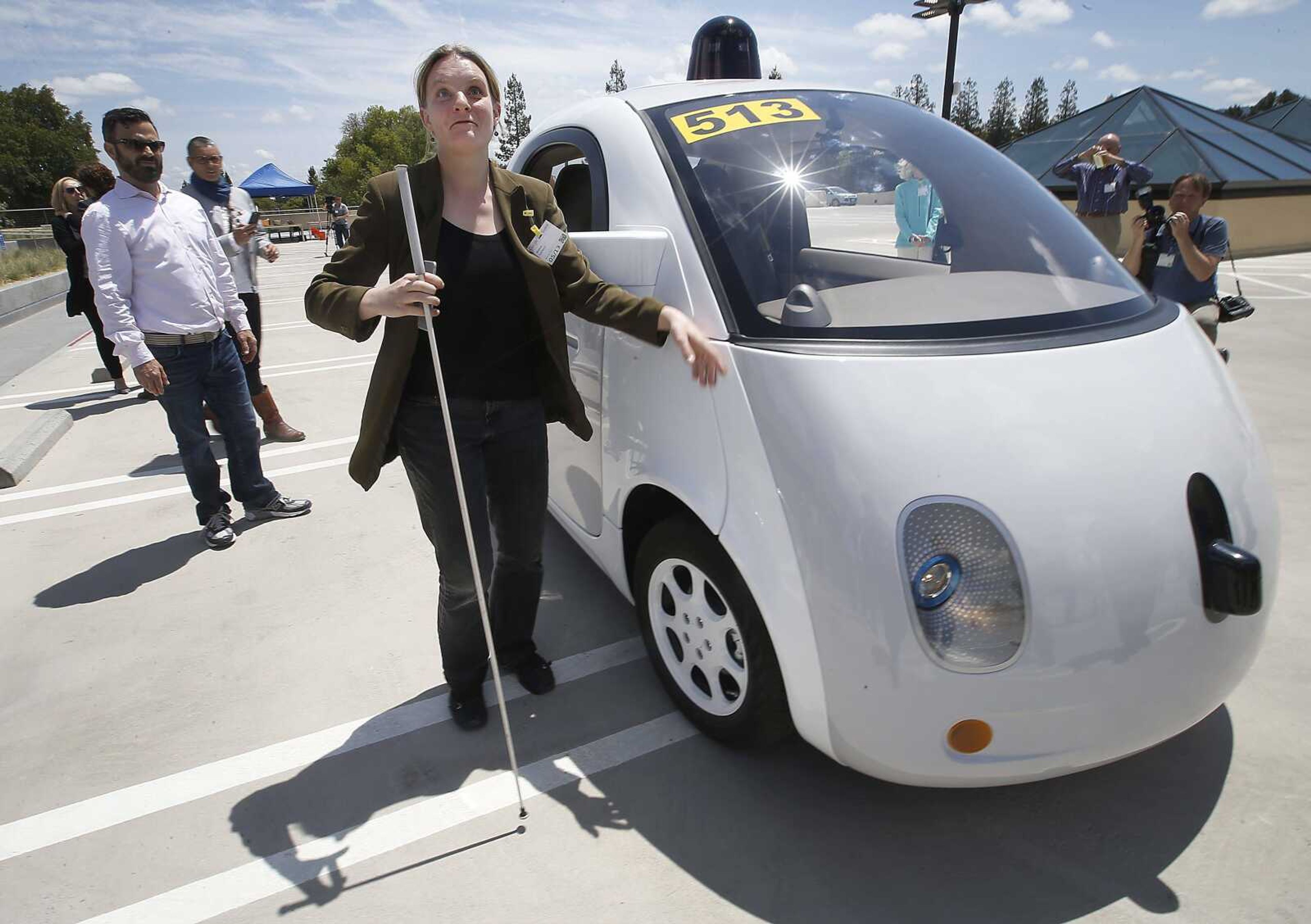 Jessie Lorenz of San Francisco touches the new Google self-driving prototype car during a demonstration Wednesday at the Google campus in Mountain View, California. The car will make its debut on public roads this summer. (Tony Avelar ~ Associated Press)