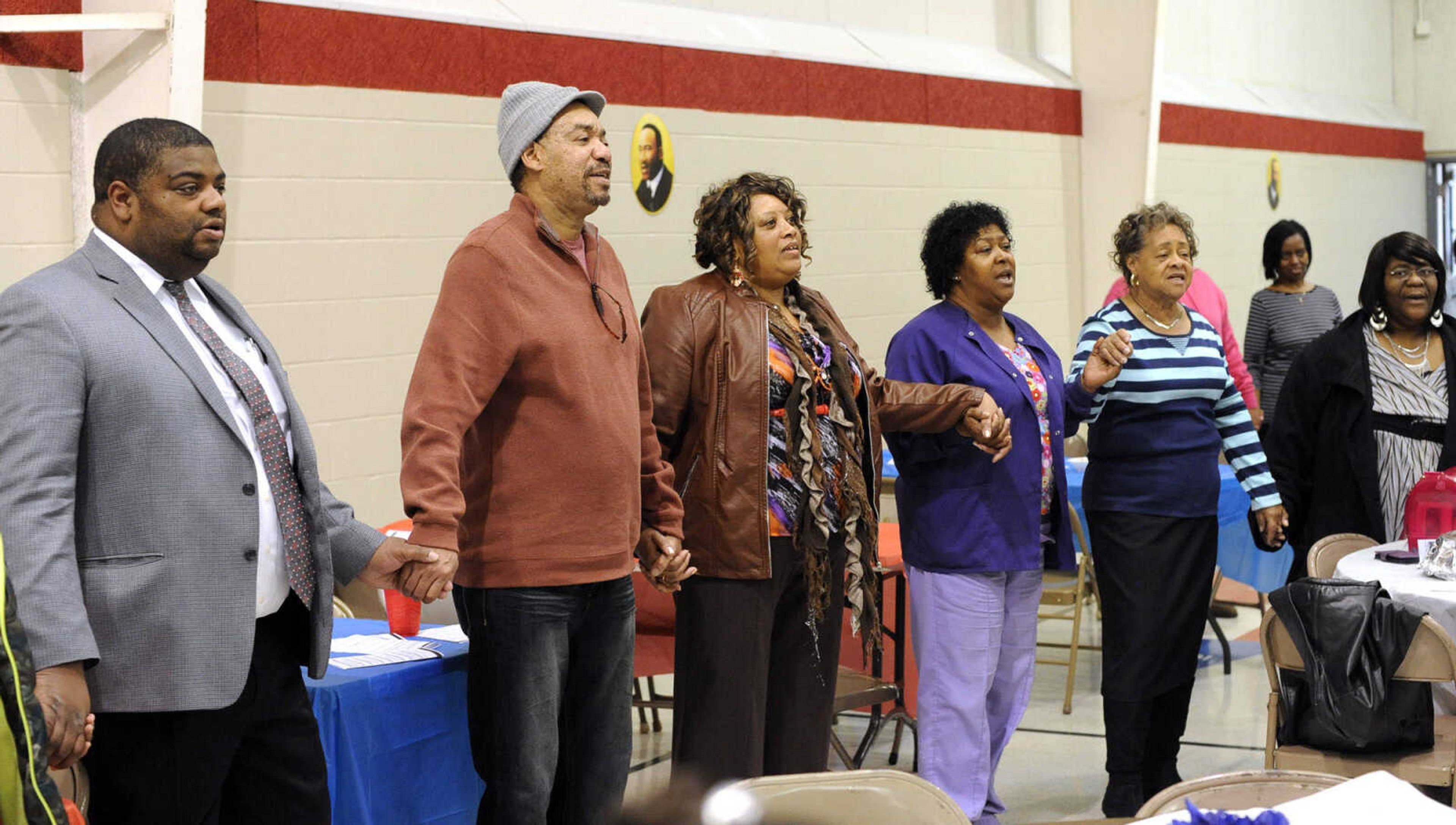 The audience sings "God Bless America" at the close of the Dr. Martin Luther King Jr. Humanitarian Luncheon Monday, Jan. 19, 2015 at the Salvation Army in Cape Girardeau