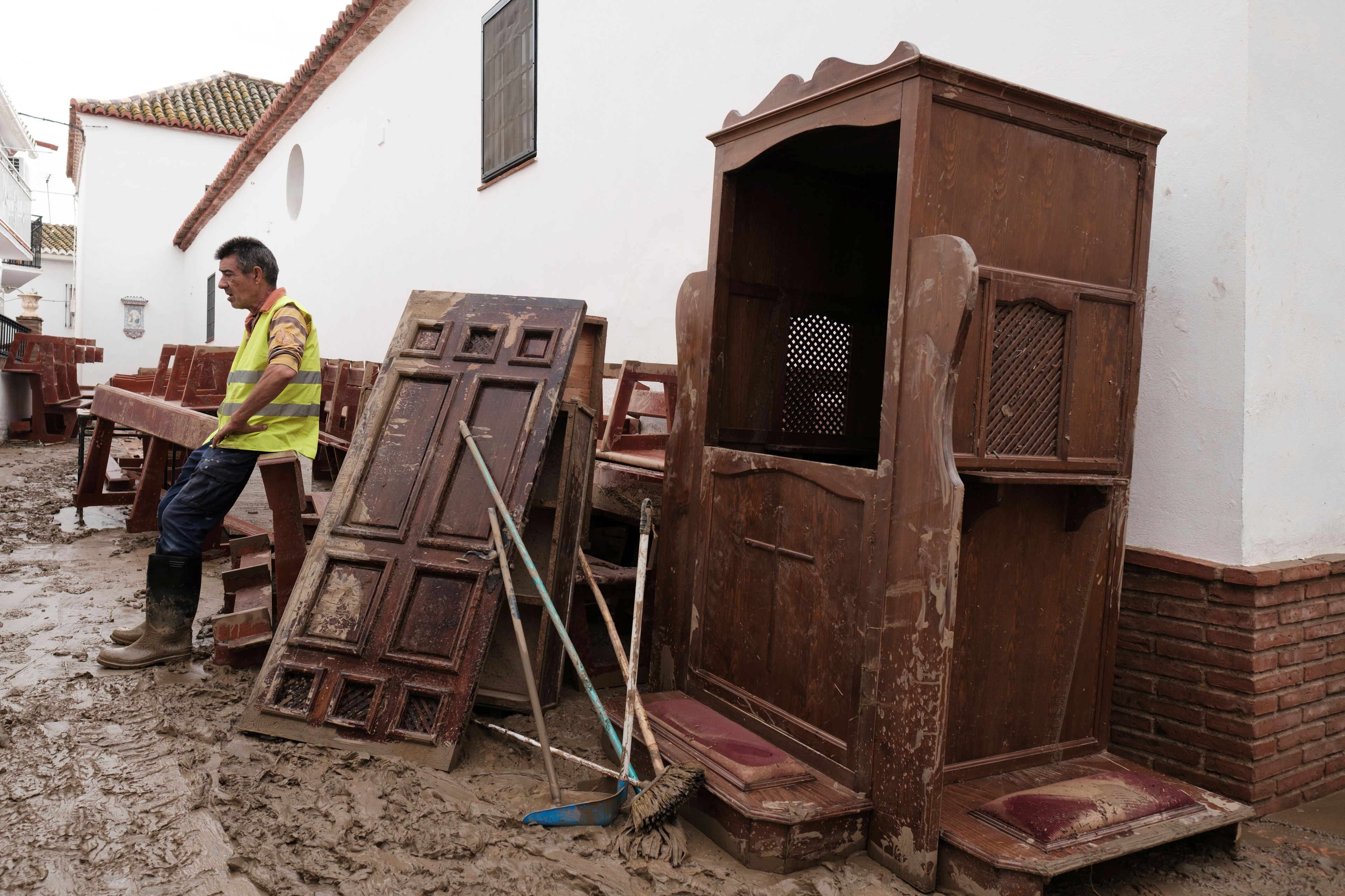 A volunteer sits in one of the pews of the church affected by the floods in Benagarmosa, Malaga, Spain, Thursday, Nov. 14, 2024. (AP Photo/Gregorio Marrero)