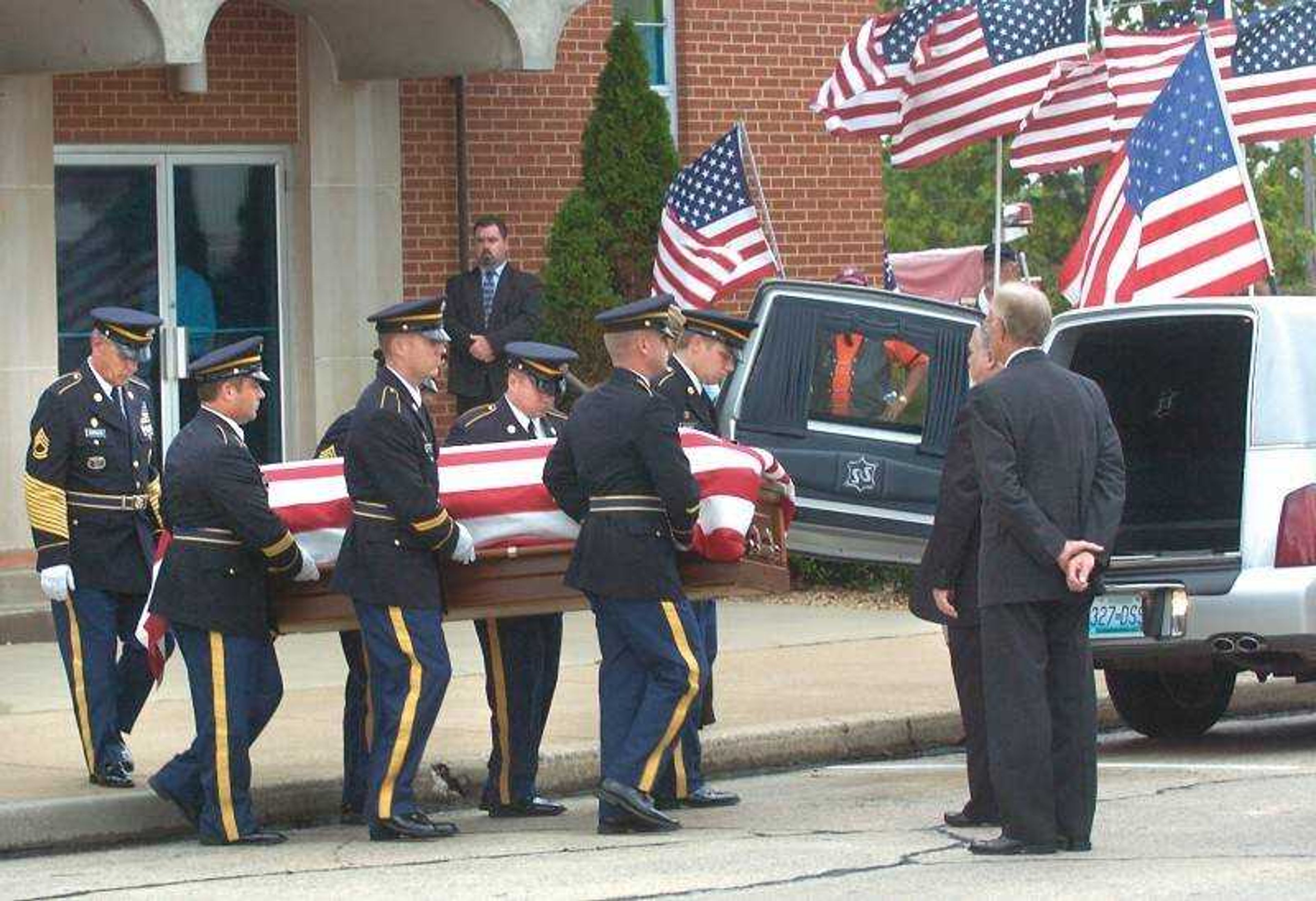 Pallbearers loaded the flag-draped casket of Cpl. Jeremy Shank into a hearse outside the First Baptist Church in Jackson Sunday afternoon. (Fred Lynch)