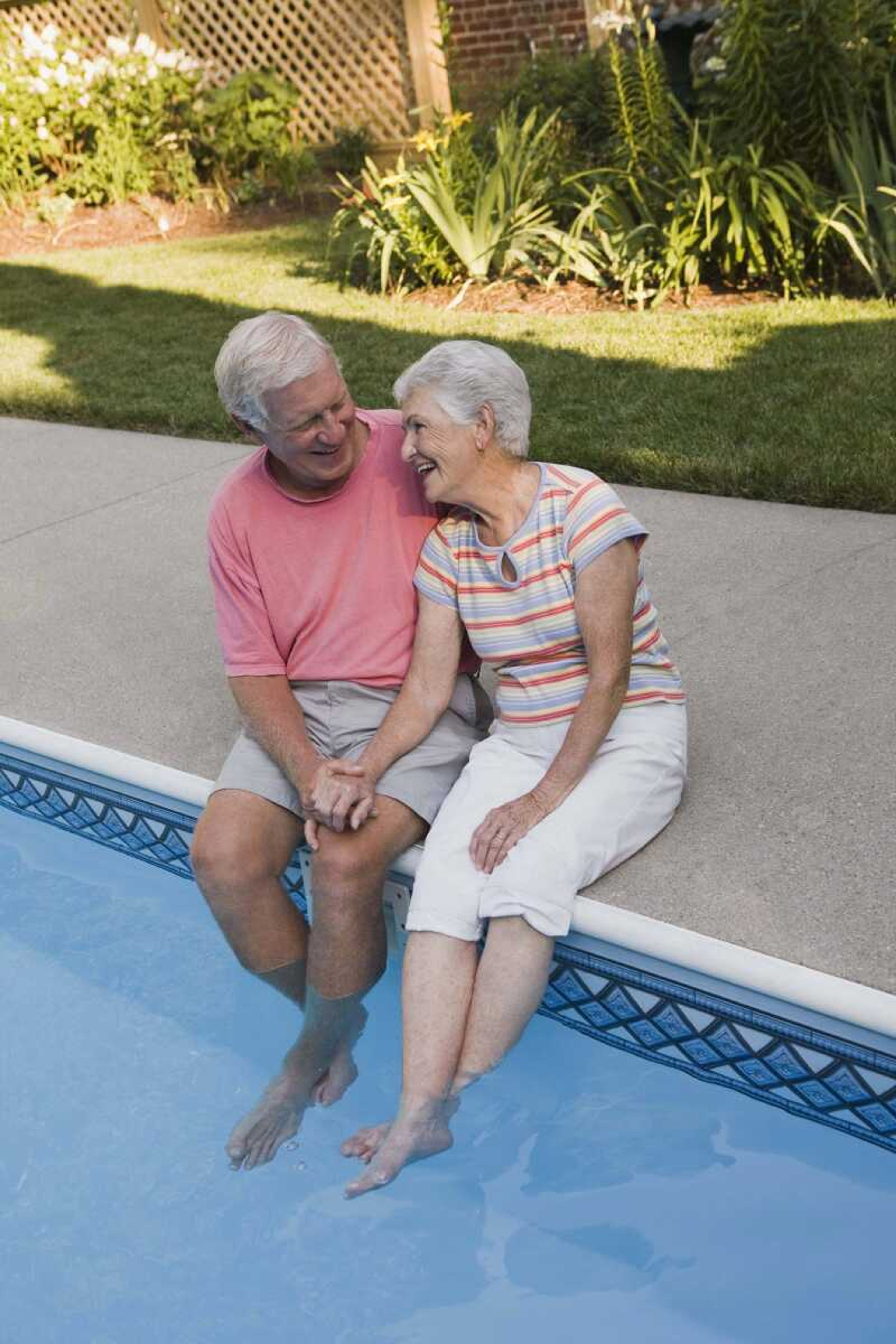 Couple sitting poolside